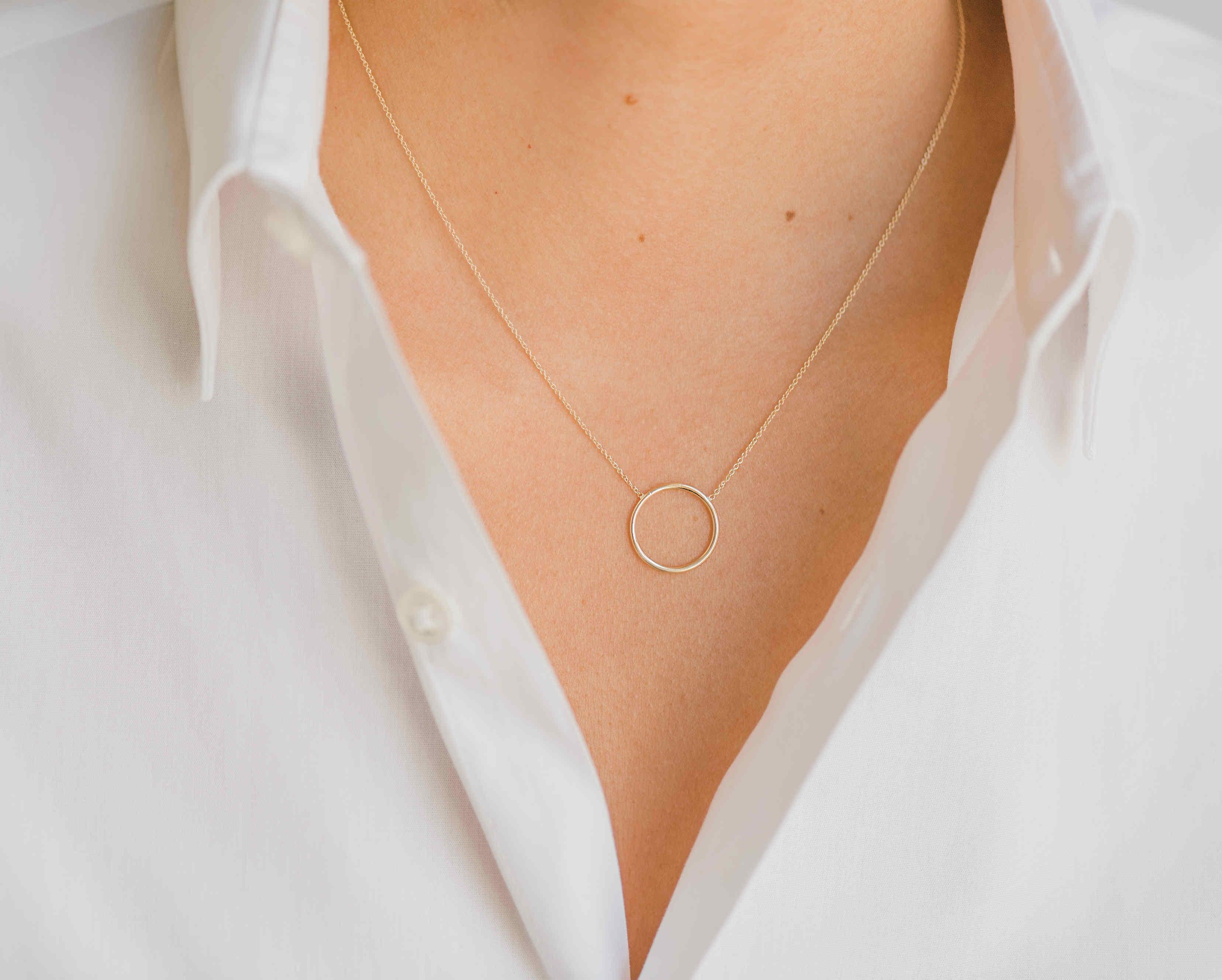 14K solid gold  circle ring necklace in 14k yellow gold. A simple, dainty and classic piece, sits beautifully by itself or layered, an everyday kind of necklace that will be your new obsession!

Made in L.A.

Size or ring/circle: Approx. 10mm