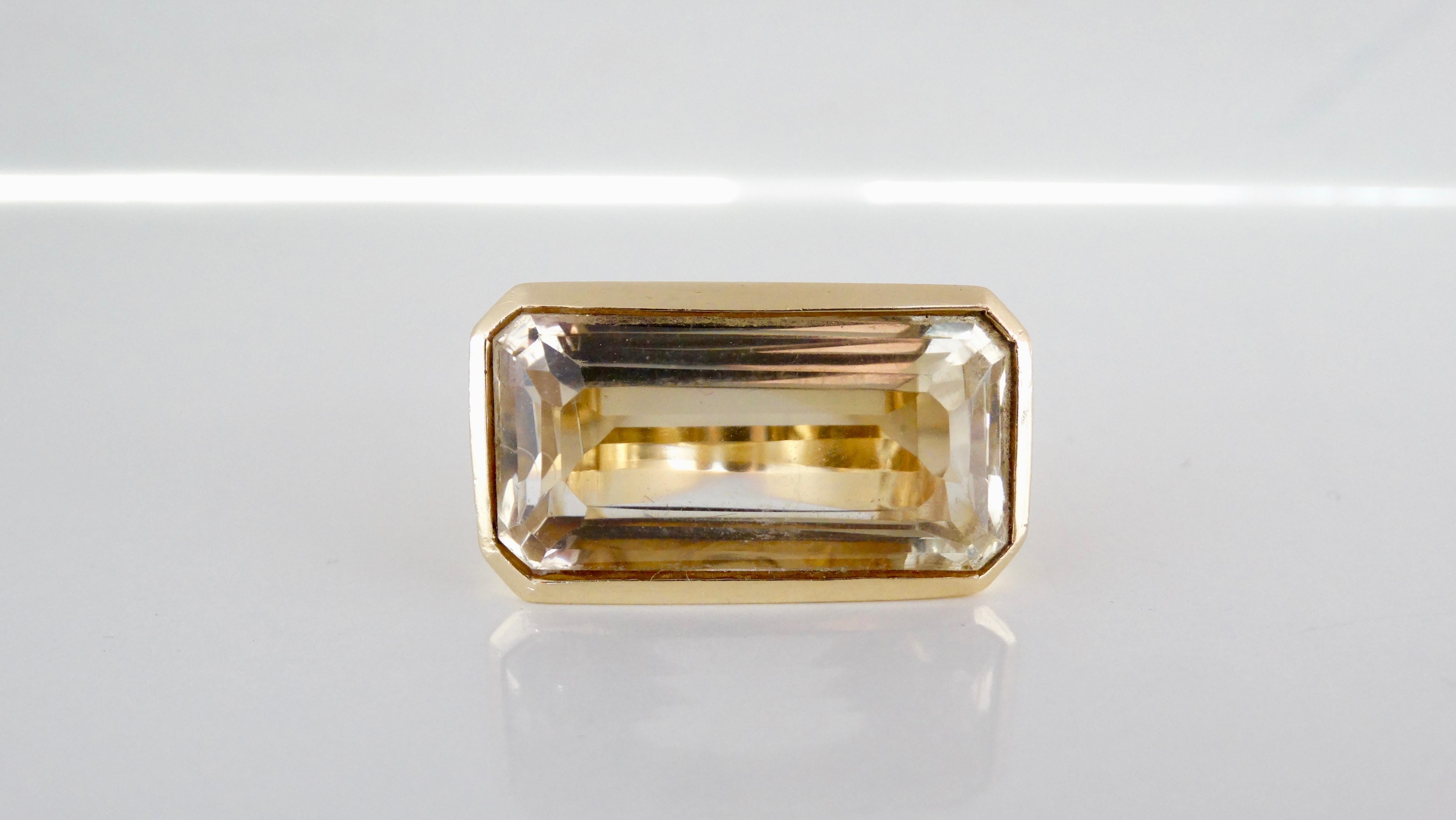 Add this vintage beauty to your collection! Circa mid-20th century, this cocktail ring is 14k Gold crafted into a chunky band with textured sides. Resting in the center is a stunning baguette cut Citrine gemstone. Ring weighs 33.61g and was made to