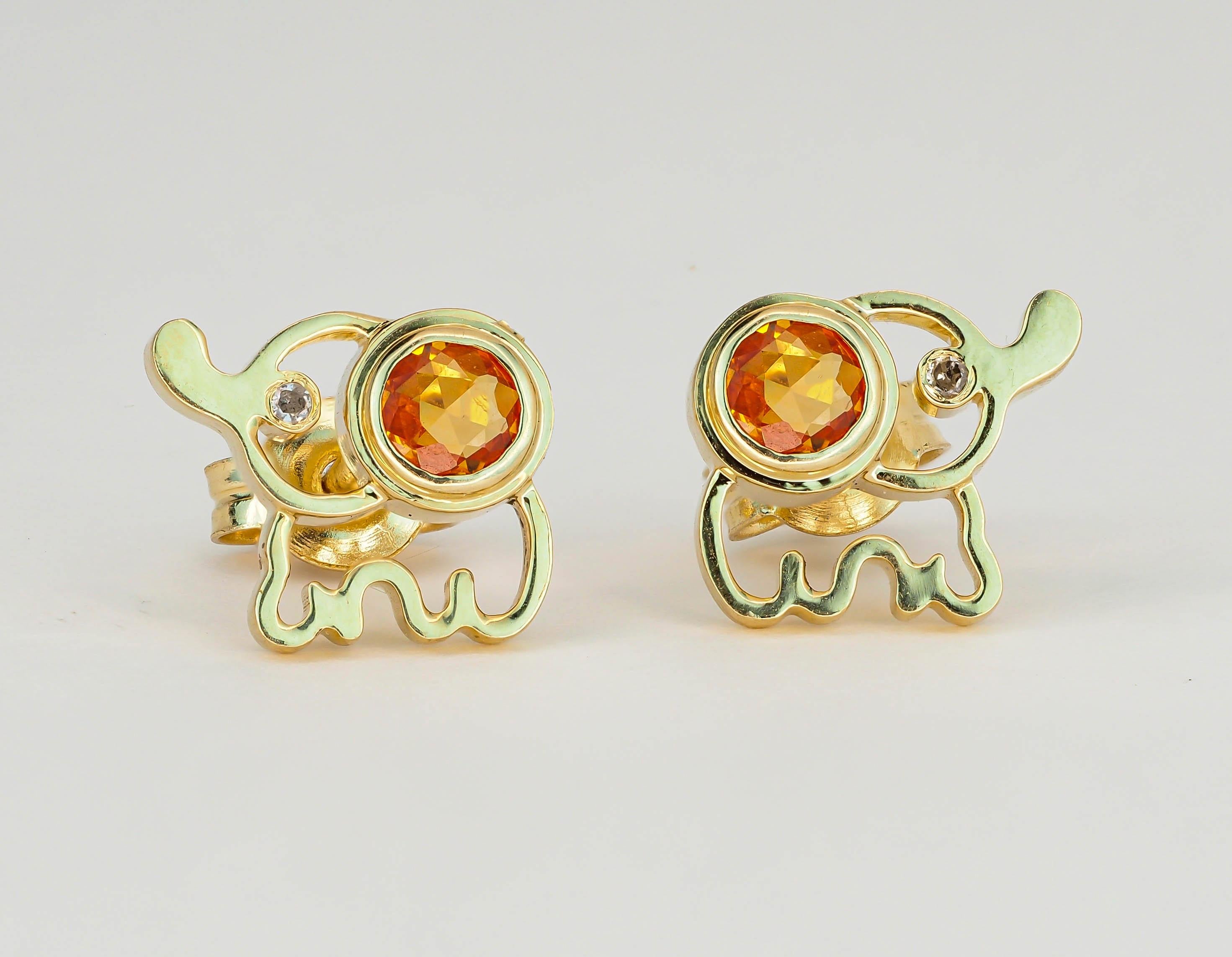 14k Gold Citrine Earrings Studs. 
Elephant earrings studs. Animal earrings. Round citrine studs. Safari gold Jewelry. November birthstone.

Total weight: 2.4 g.
Metal: 14k gold.
Size 7x8 mm.

Central stones: natural citrines - 2 pieces
Cut: