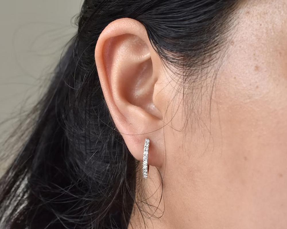 Classic pave diamond huggies earrings set in solid 14K gold. dainty 16mm hoop earrings perfect by itself or paired with other earrings. perfect to wear anytime also day to day wearing they will go with everything a must have pair of hinged tiny hoop