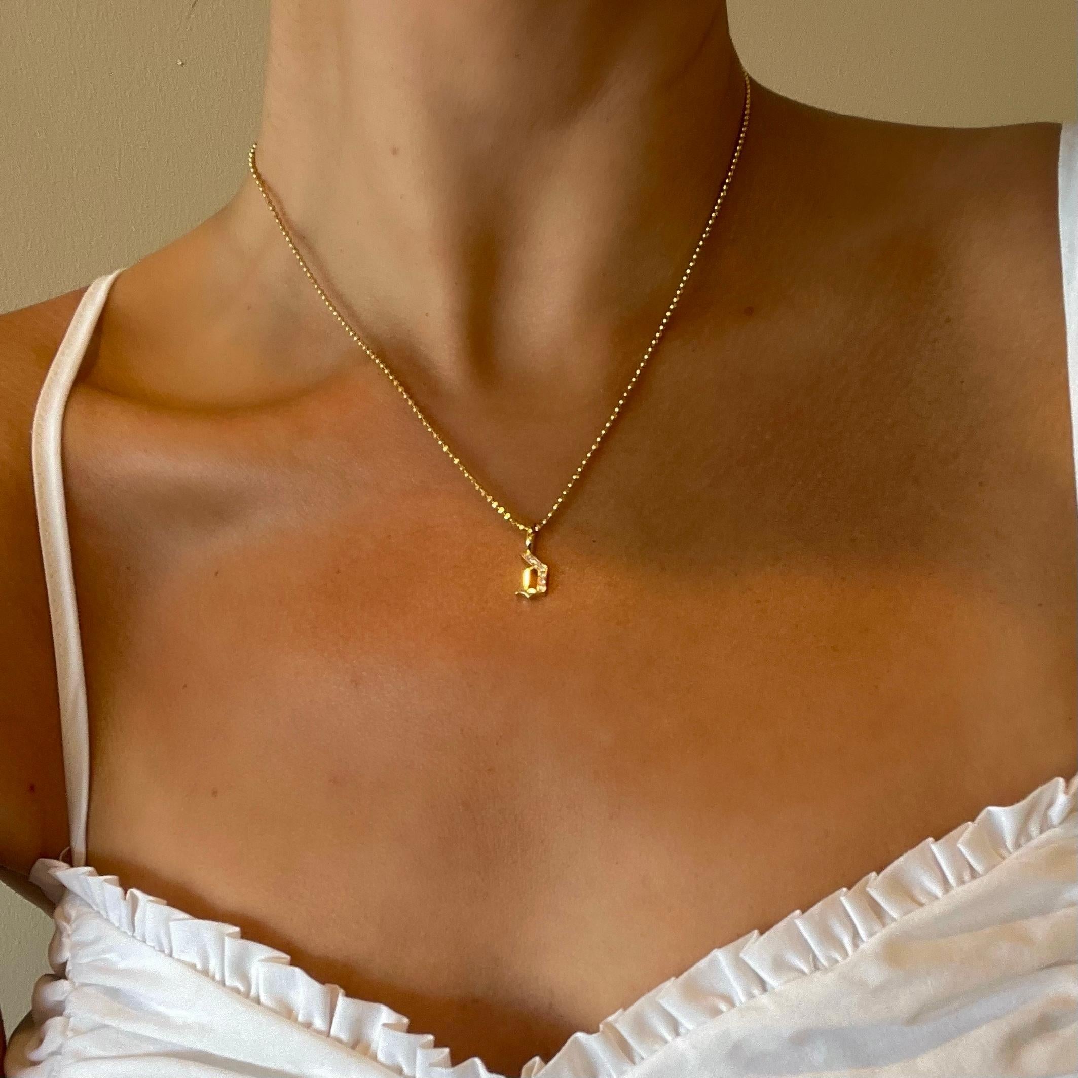 LIMITED TIME SUMMER SALE

Meticulously crafted from solid 14k gold, this diamond-cut ball chain and gothic style diamond “a” captivates with its intricate faceting that catches and reflects light with every subtle movement. Paired with our signature