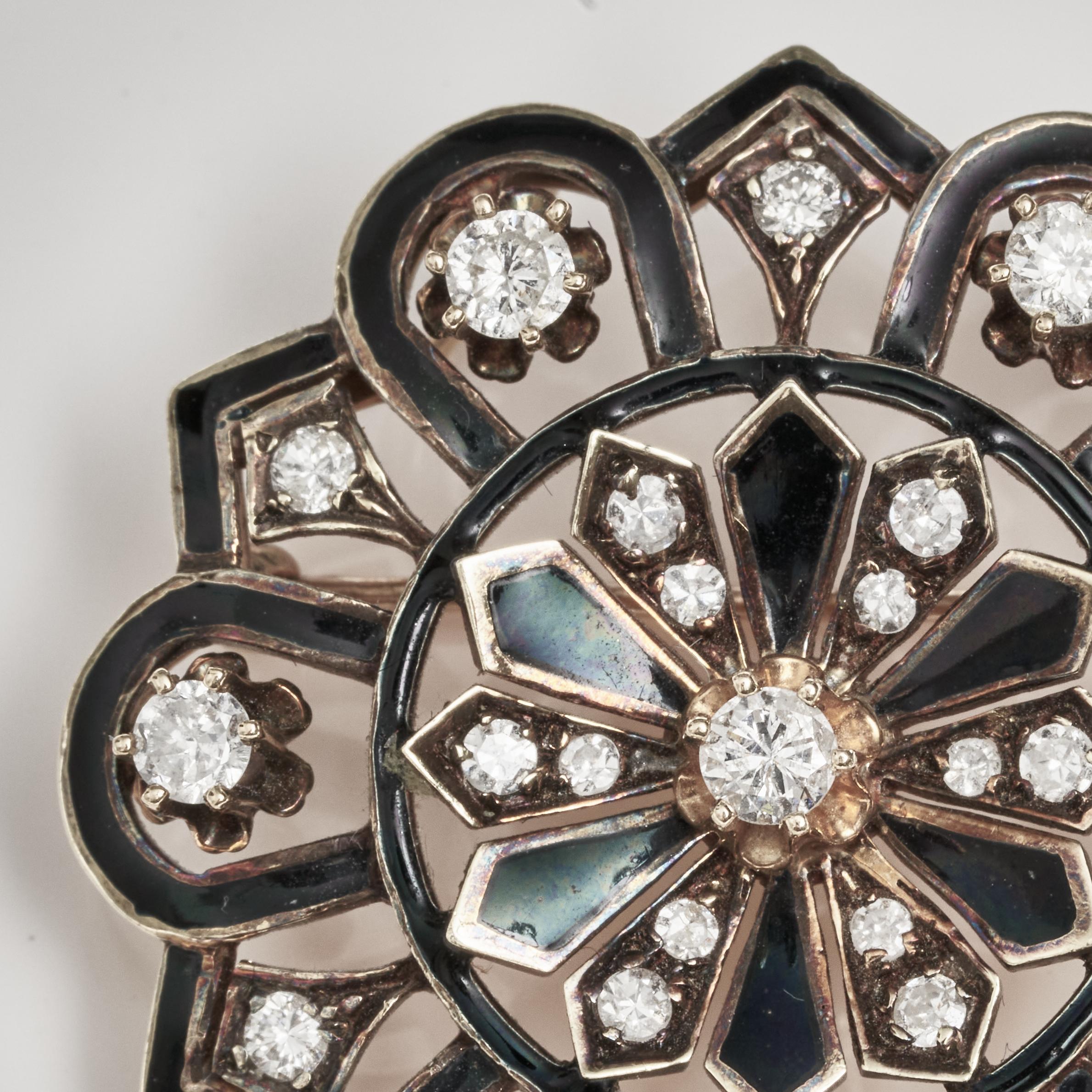 A diamond, enamel and 14K gold brooch featuring black enamel overall, surrounded by twenty-five round single and brilliant cut diamonds, weighing an estimated total of approximately 1.10cts. diameter 1 3/8in; gross weight approximately 11.8 grams