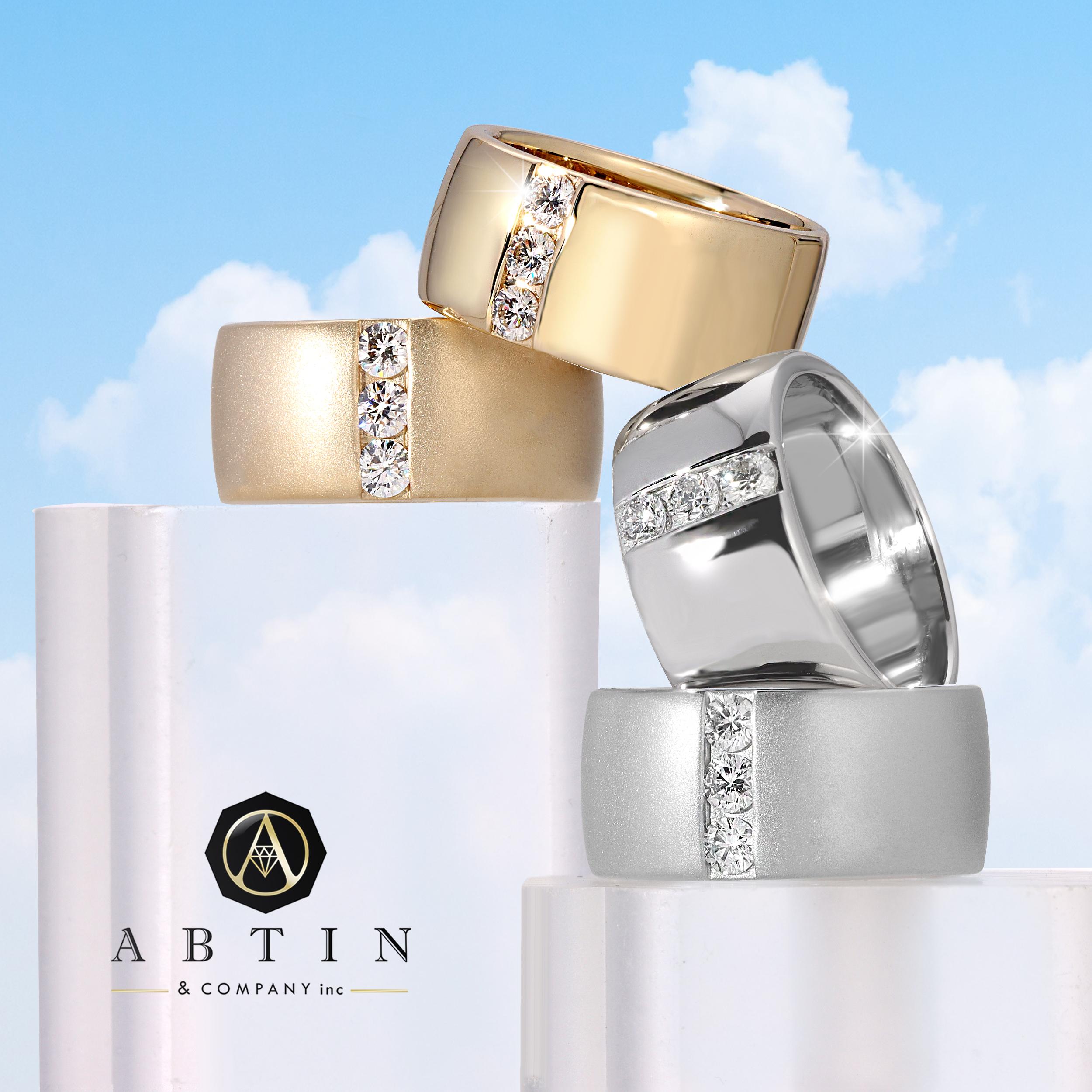Crafted in 14K gold this contemporary cigar ring features the time-less ring shape split down the middle with a line of glistening floating diamonds. This contemporary cigar ring is the perfect addition to your ring stack. This piece is a must have