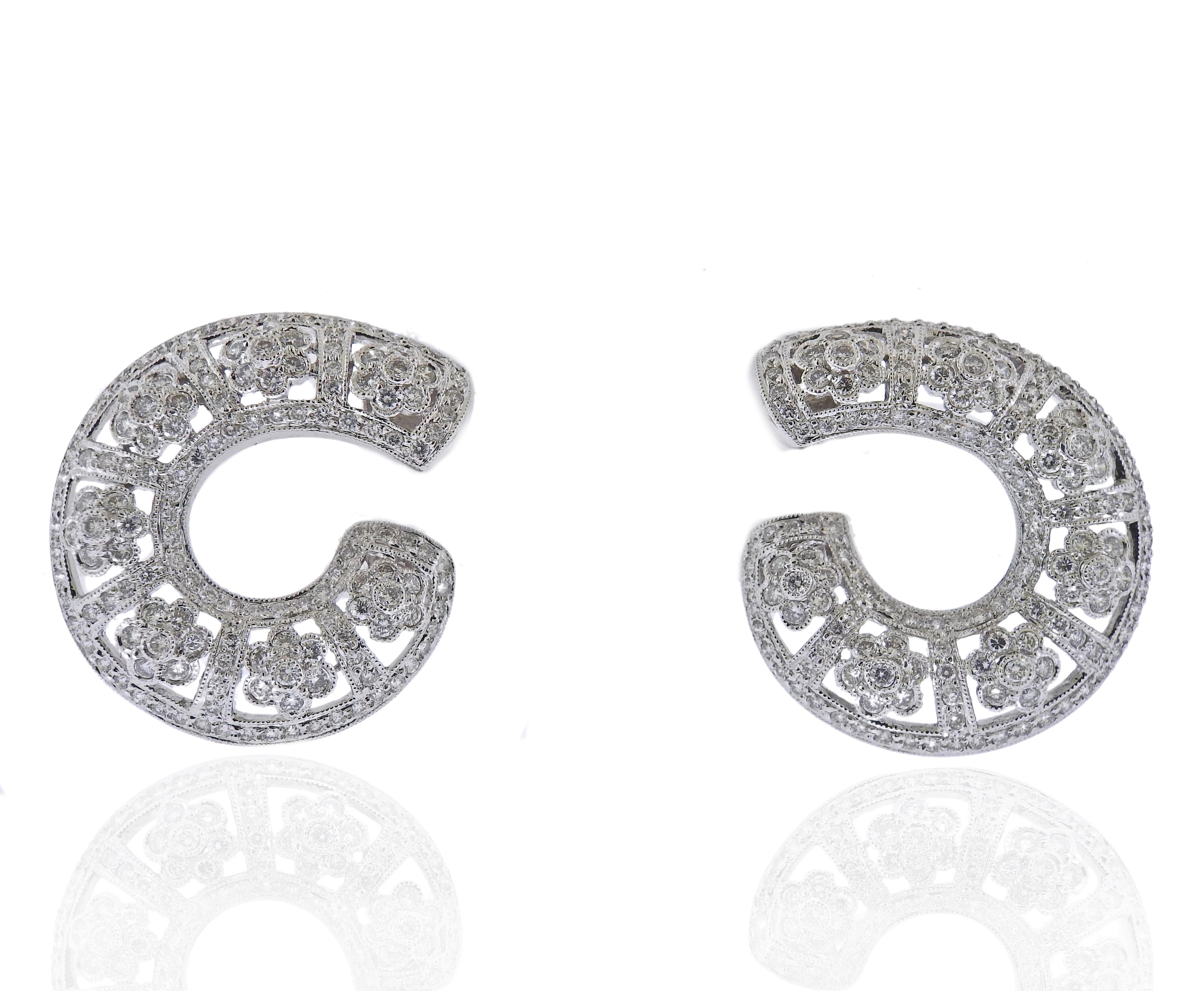 Pair of 14k gold earrings with approx. 1.40ctw in diamonds. Earrings are 32mm x 28mm. Marked 585, Weight 12.5 grams. 