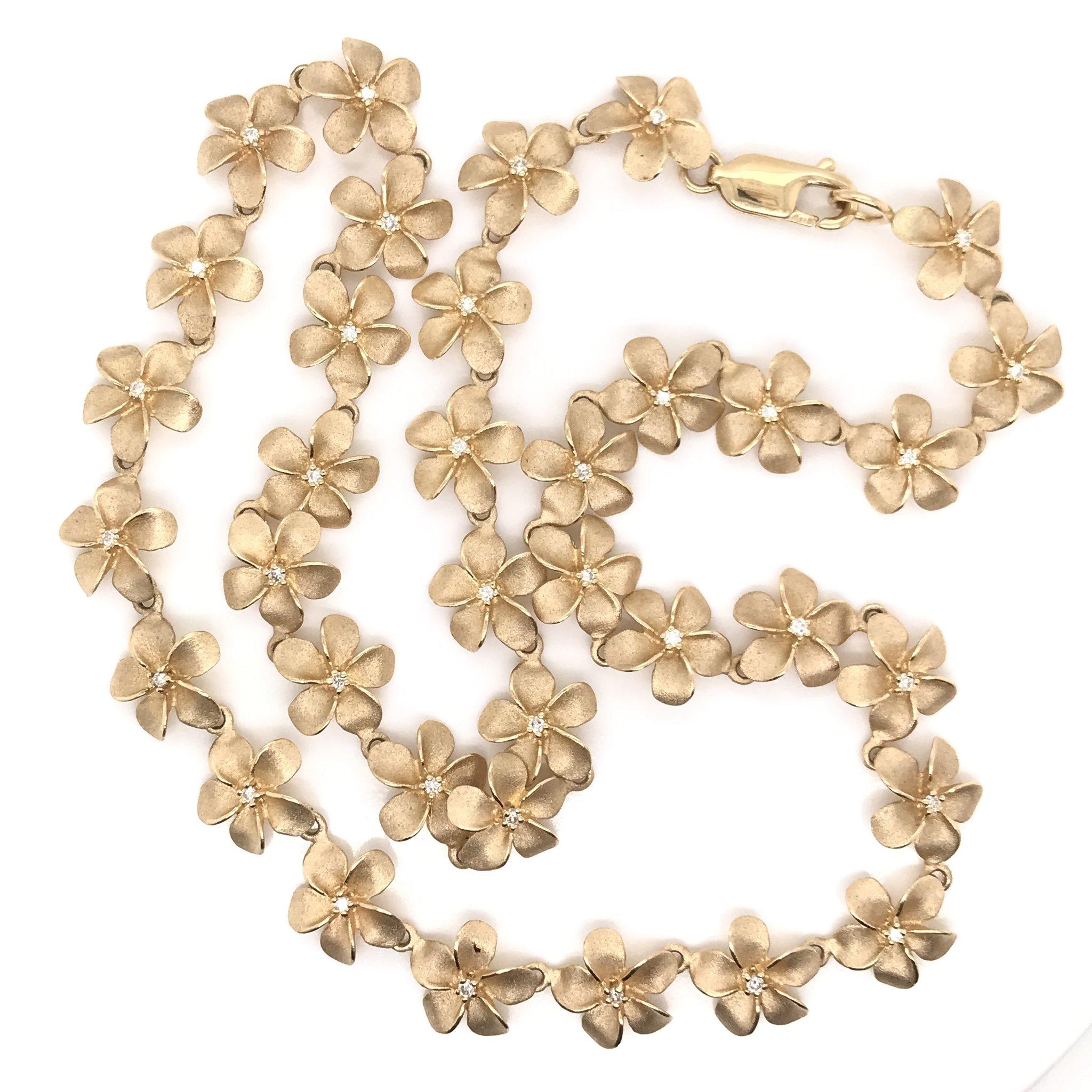 This is an estate piece. This charming necklace is made from 36 14k yellow gold sculpted flower links, each featuring a tiny sparkling accent diamond in the center. The necklace's total combined diamond weight measures approximately 0.50 carats.
