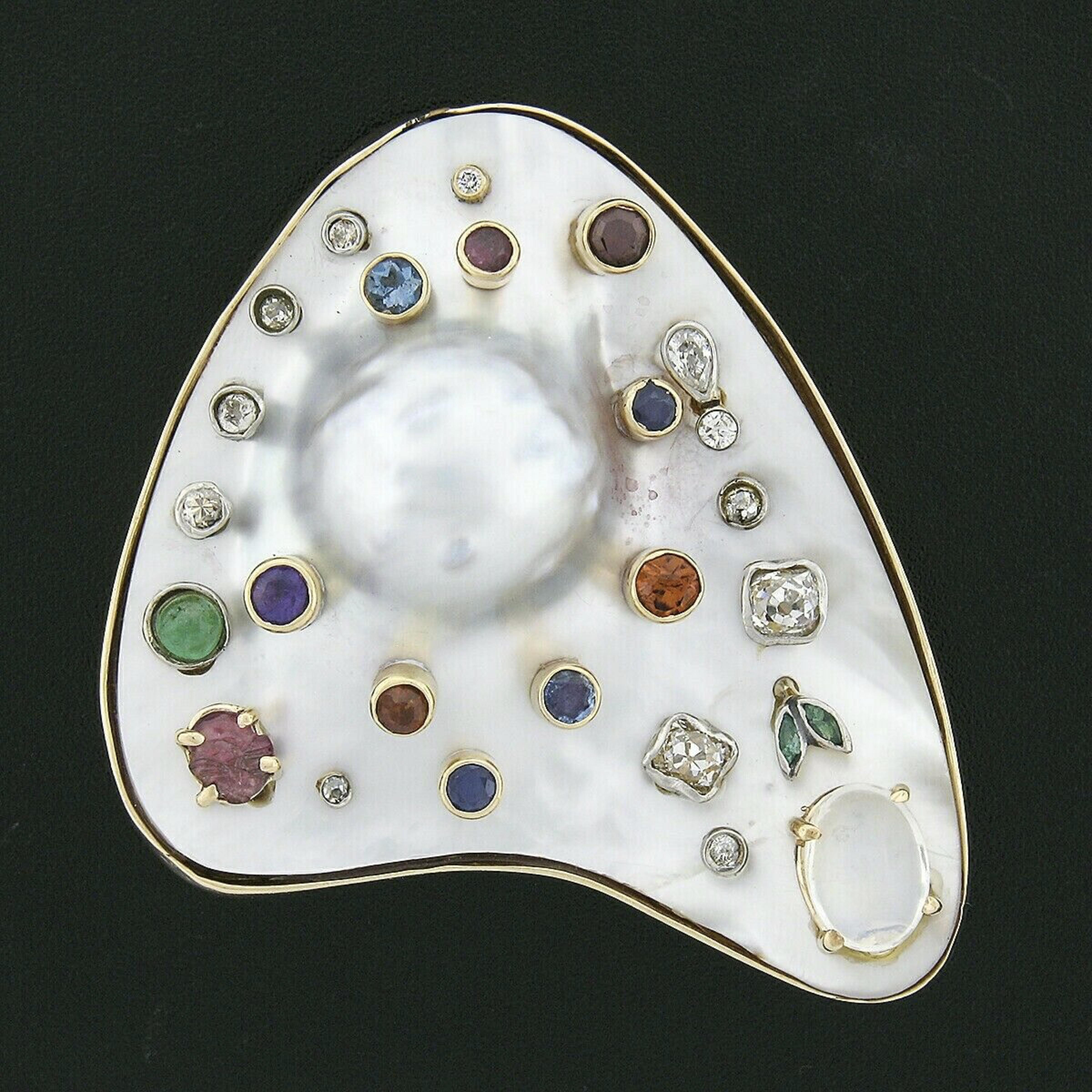 This magnificent, handmade, vintage brooch or pendant is crafted from solid 14k yellow gold. It features a unique artists pallet design constructed from a large baroque pearl in which is set with fine quality diamonds and natural gemstones accents