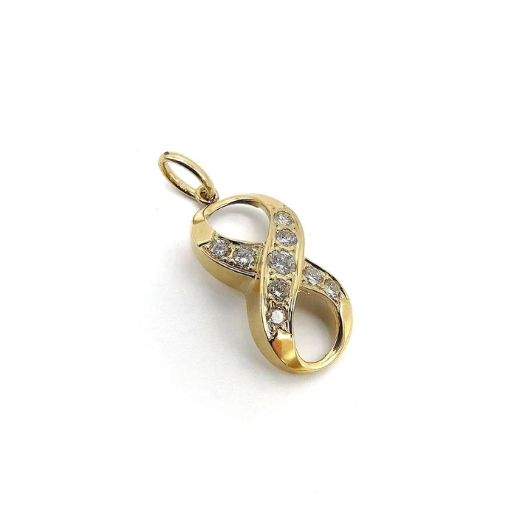 This is a sinuous infinity or lucky 8 pendant. Crafted in 14 karat yellow gold, the lines of the infinity gracefully crosses over and intertwines creating a beautiful form.  In the center is a 3.5 mm round cut diamond that is flanked by 8 more bead