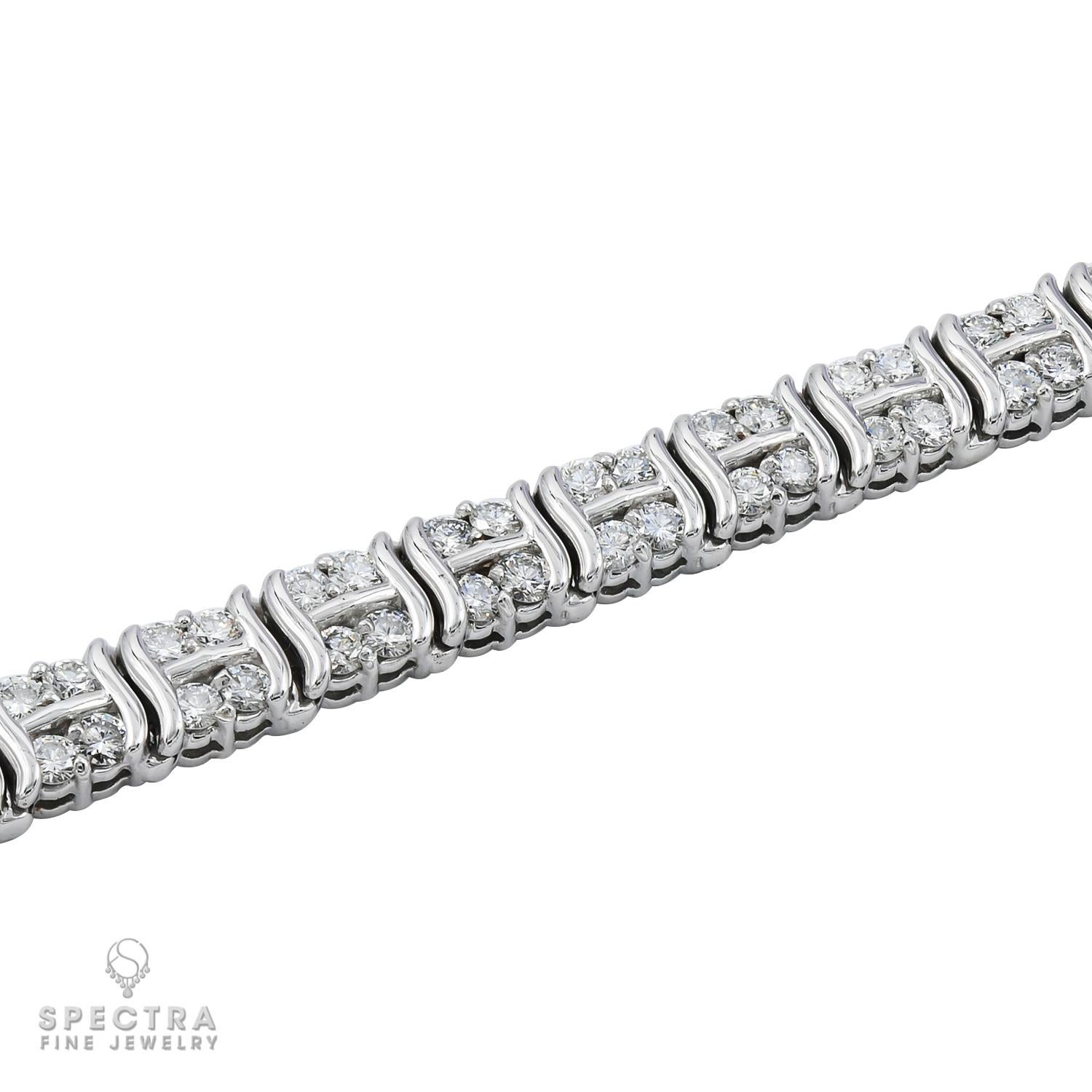 A line bracelet made with diamonds in 14k white gold.
104 round diamonds, weighing a total of 5.2 carats, most with H-I color, VS-SI clarity.
Each diamond is 0.05 carat.
Length is 7 inch.
Gross weight 23.28 gram.