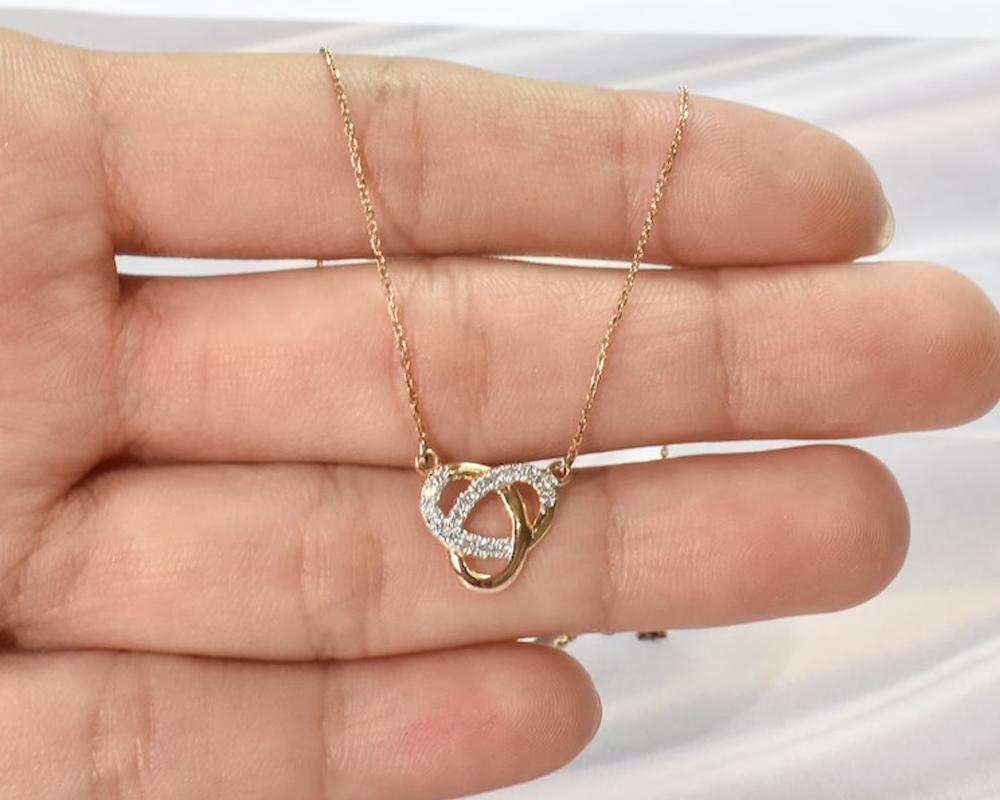 Diamond Love Knot Necklace is made of 14k solid gold.
Available in three colors of gold: White Gold / Rose Gold / Yellow Gold.

Beautiful minimalist love necklace made with 14k Gold featured with natural sparkly 0.12 ct. round diamond pave set by a