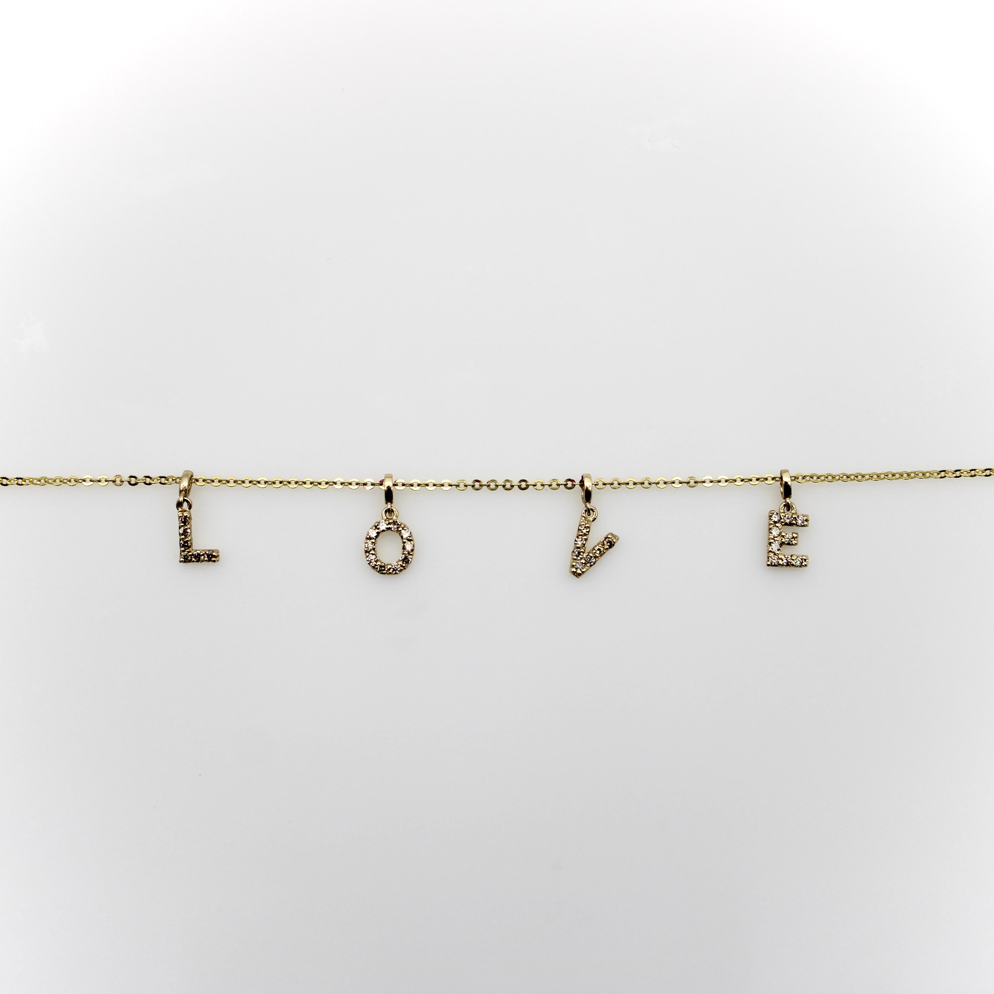 Suspended on a delicate 14k gold chain are 4 micro pave diamond letters that spell the word LOVE. The letters are spaced close enough together so that the word love is easy to read, but with enough width between them to allow the letters to dangle