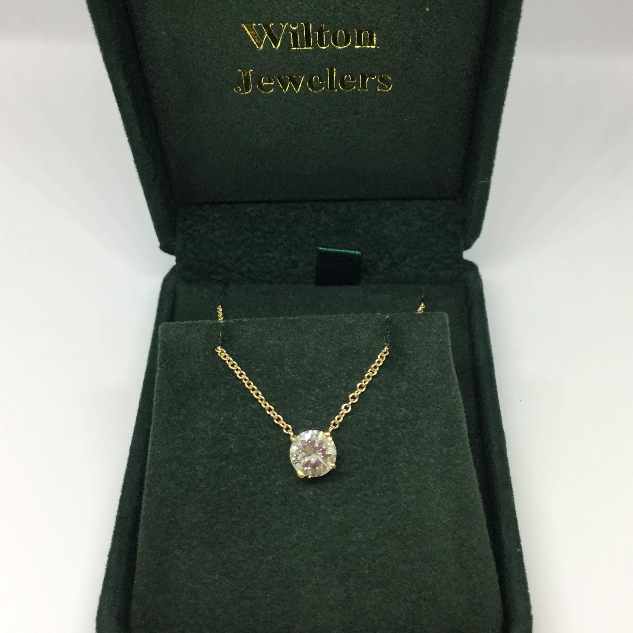 14k Yellow gold diamond pendant necklace. The pendant contains one round brilliant cut Diamond. The diamond is GIA certified report number 1206238313. The diamond weighs 1.77 ctw, N/SI1. The diamond is set in a four prong wire basket. The chain is