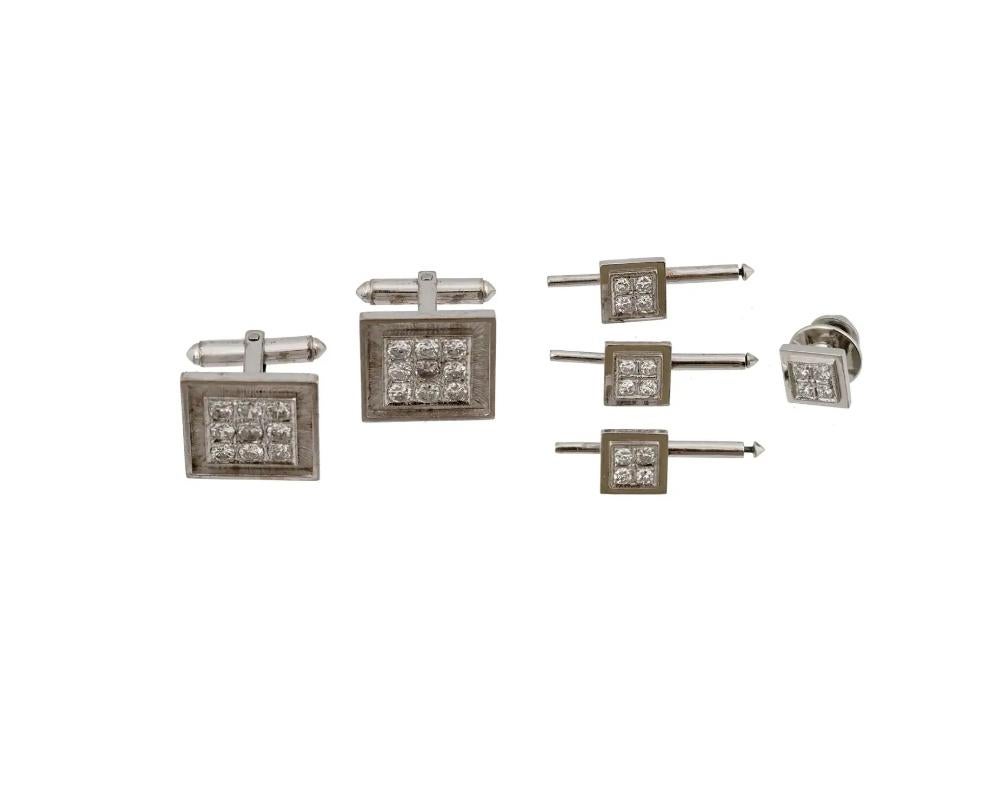 A 14K White Gold cufflinks, and a stud set with a tie pin. The wares are made in a rectangular shape, and adorned with a ribbed design. The wares are encrusted with Diamonds. Marked with a standard Gold hallmark. Weight 23.5 grams. Vintage and