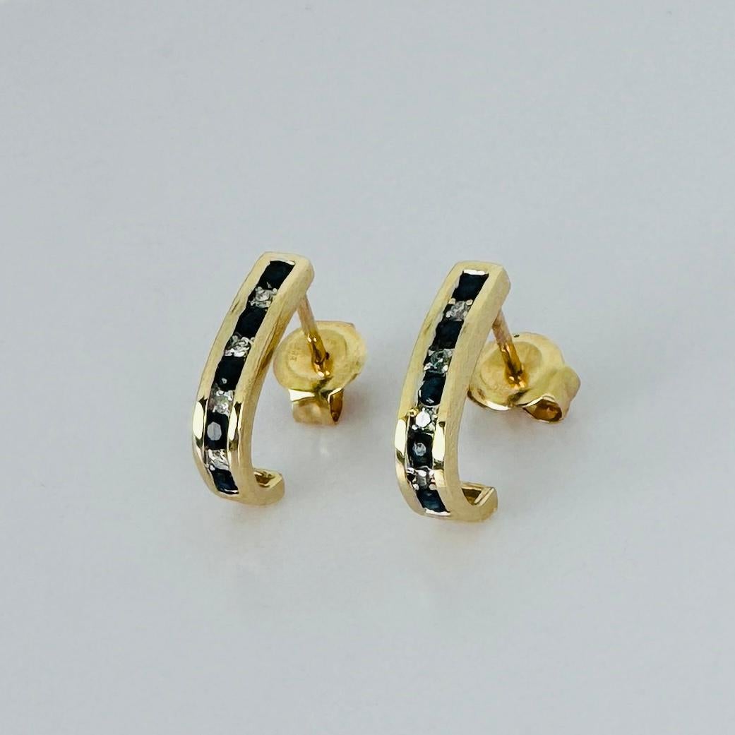 Elevate your style with these exquisite vintage 14K gold earrings with 5 blue sapphires and 5 brilliant cut diamonds. It is a true testament to timeless sophistication. Each earring features two stunning sapphires and two brilliant-cut diamonds,