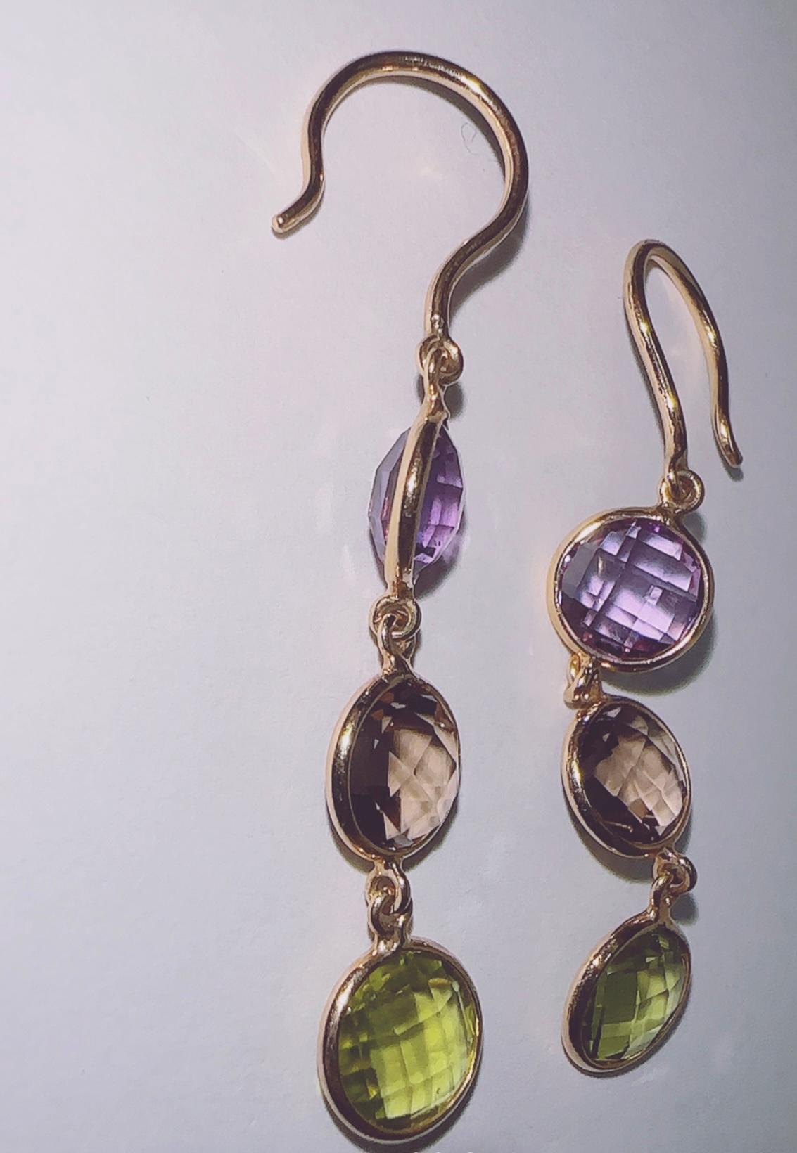 Beautiful double checkboard earrings that look great on both sides! Made of 14K gold with all natural stones, Amethyst, Smokey Topaz and Peridots all rounds. 