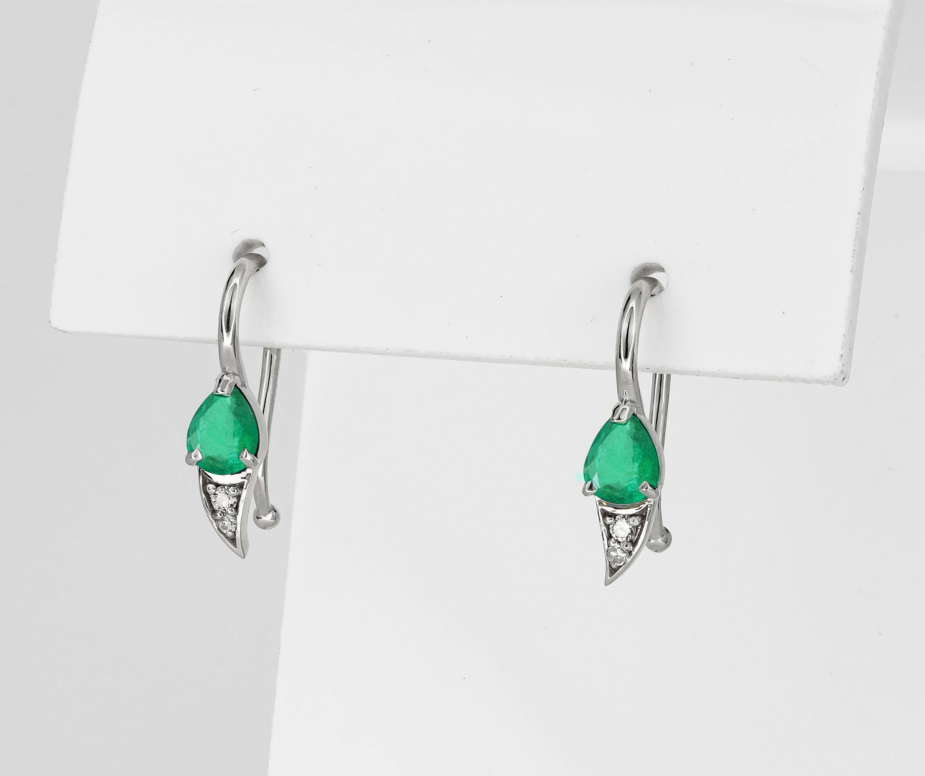 Pear Cut 14k gold earrings with natural emerald and diamonds.  For Sale