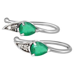 14k gold earrings with natural emerald and diamonds.