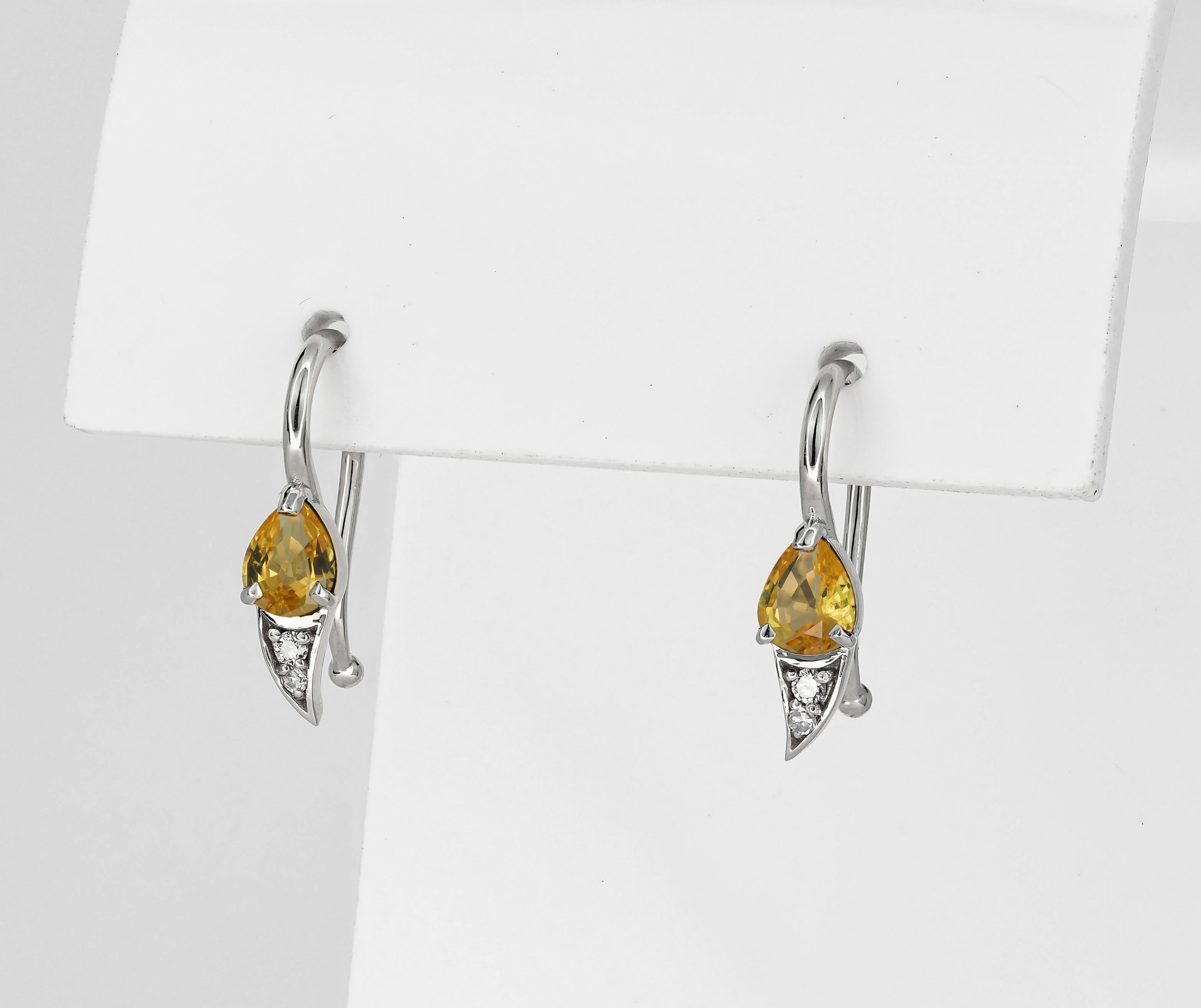 Modern 14k gold earrings with natural sapphire and diamonds.  For Sale