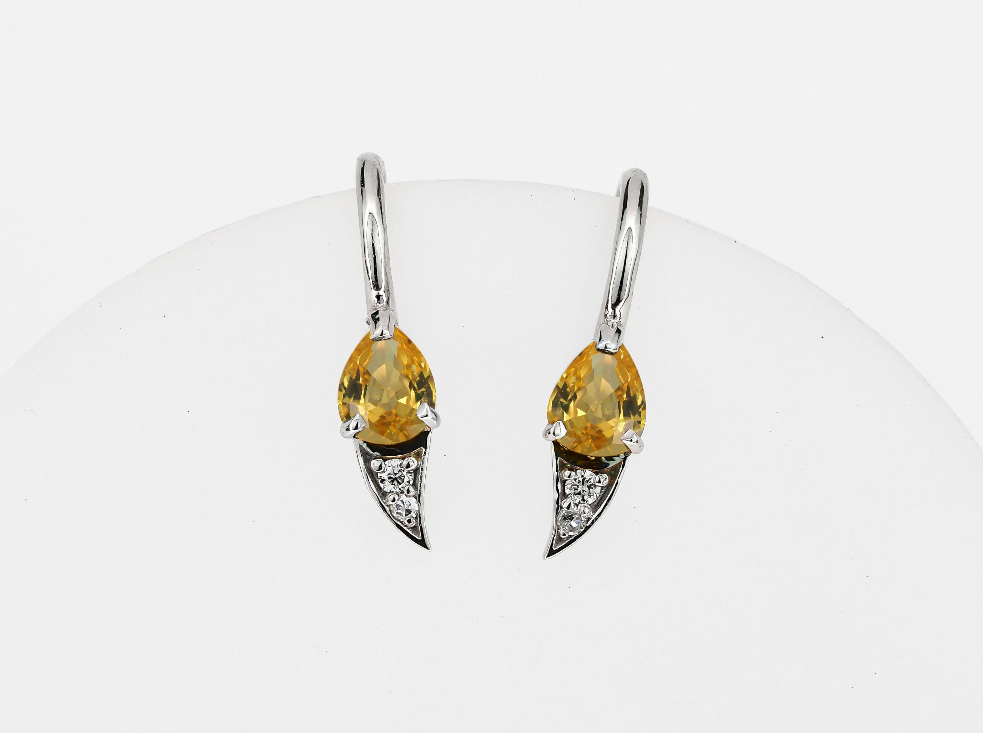 Women's 14k gold earrings with natural sapphire and diamonds.