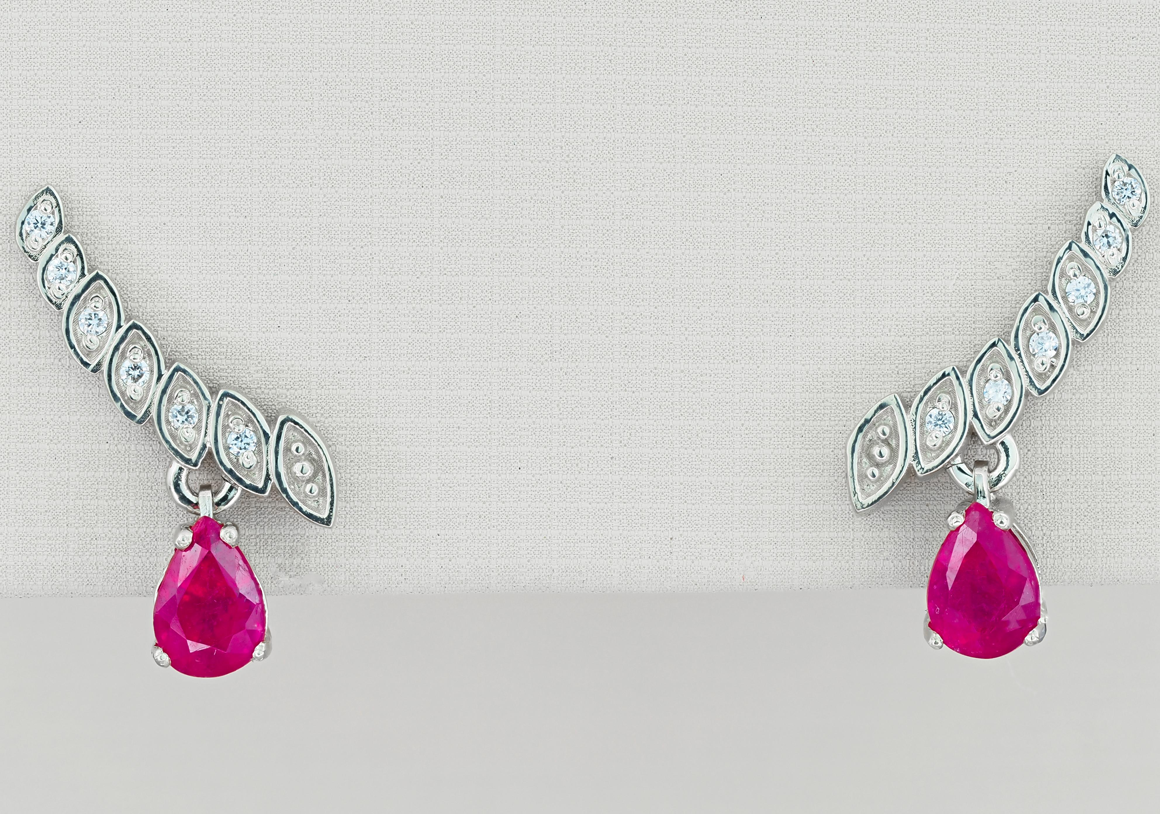 14kt solid white gold earrings with pear natural rubies and diamonds. July birthstone.
Total weight: 2.3 g.
Size: 15.5 x 10 mm.

Central stones: Natural rubies - 2 pieces
Weight: approx 1.40 ct total (6 x 4 mm each), cut - pear.
Color: red, clarity