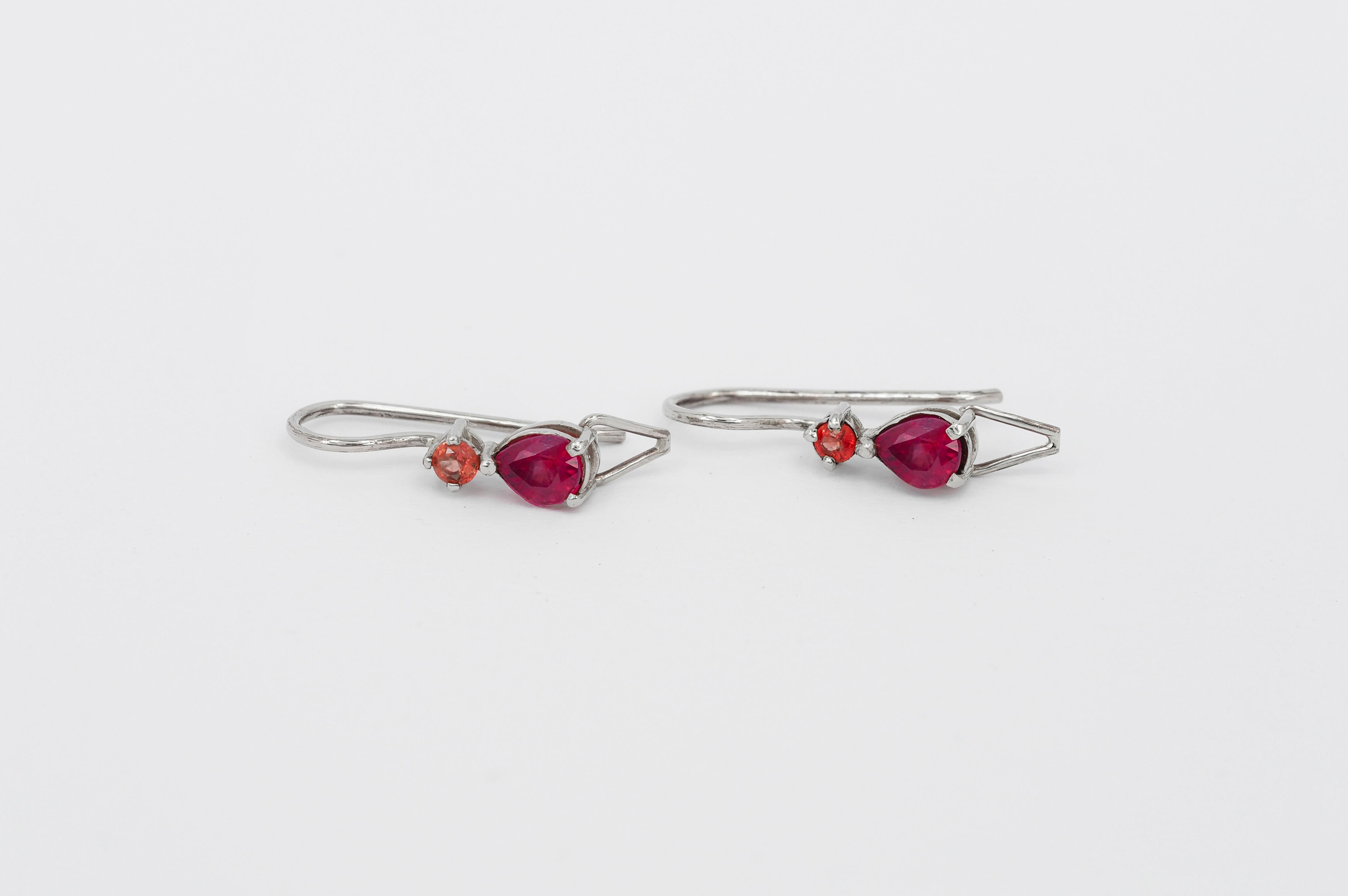 14 kt solid gold earrings with natural sapphires and rubies. Small tinny earrings. September birthstone. July birthstone.
Weight: 1.63 g.
Size: 17.6 x 5 mm.

Central stones: Natural rubies
Weight: 0.84 ct total (2 pieces x 0.42 ct), pear