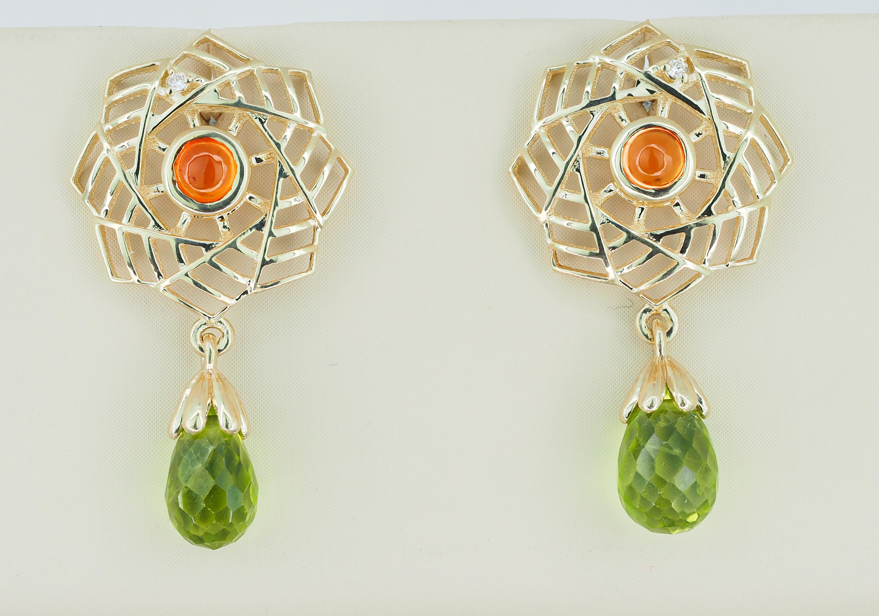 14k gold earrings with peridots, sapphires and diamonds. 
Peridot earrings in 14k gold. Yellow sapphire earrings in 14k gold.

Material: 14k gold
Weight: 2.60 g.
Earrings size: 25 x 14 mm.

Peridots:
2 pieces, green - color, briolette cut,