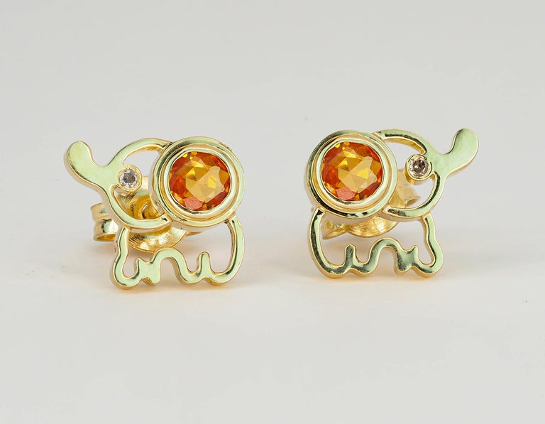 14 kt solid gold elephant earrings studs with natural yellow sapphires. September birthstone.
Total weight: 2.4 g.
Size: 7 x 8 mm.
Central stones: Natural sapphires - 2 pieces
Weight: approx 0.85 ct total (4 mm each), cut - round
Color: Yellow,