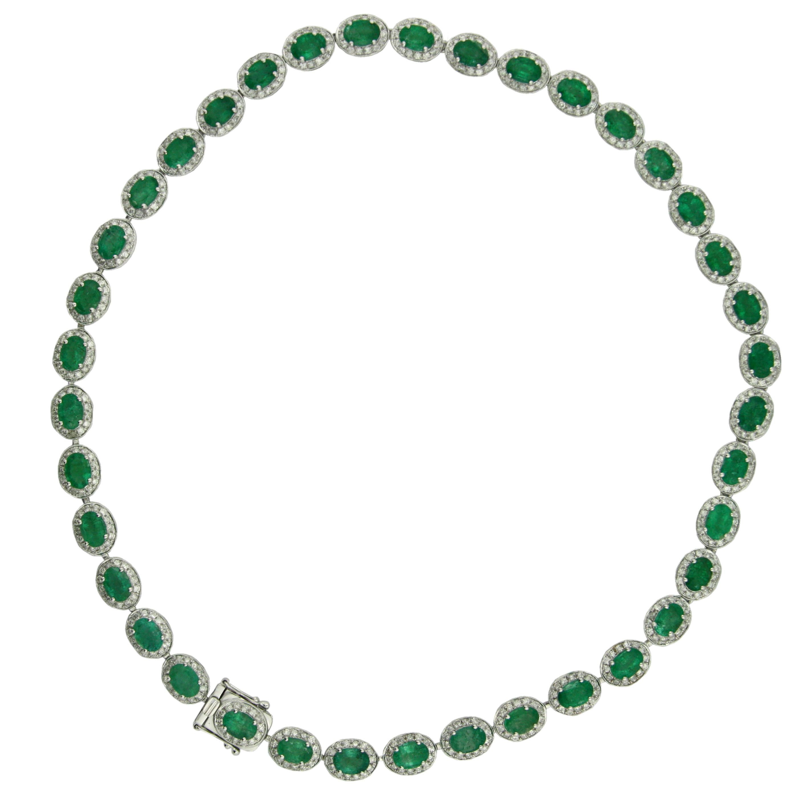 14K Gold Emerald and Diamond Necklace 
Featuring thirty-eight oval-shaped step-cut natural emeralds, each measuring 7 x 5 mm, weighing approximately 27.46 carats,  
Emeralds set within a surround of five-hundred thirty-two round, brilliant-cut