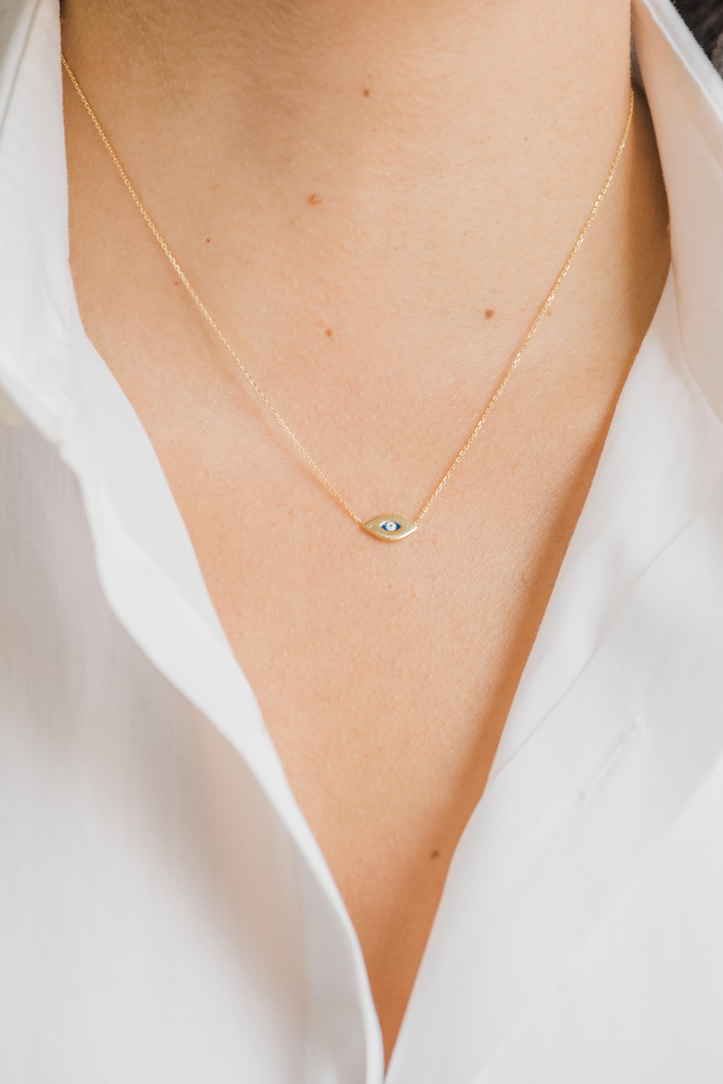 14k solid gold dainty evil eye charm hanging form an adjustable 16'' to 18'' cable link chain necklace,in 14k yellow gold. Lays beautifully by itself or layered, wear it up or down, day and night, this necklace will be your new obsession!

Size of