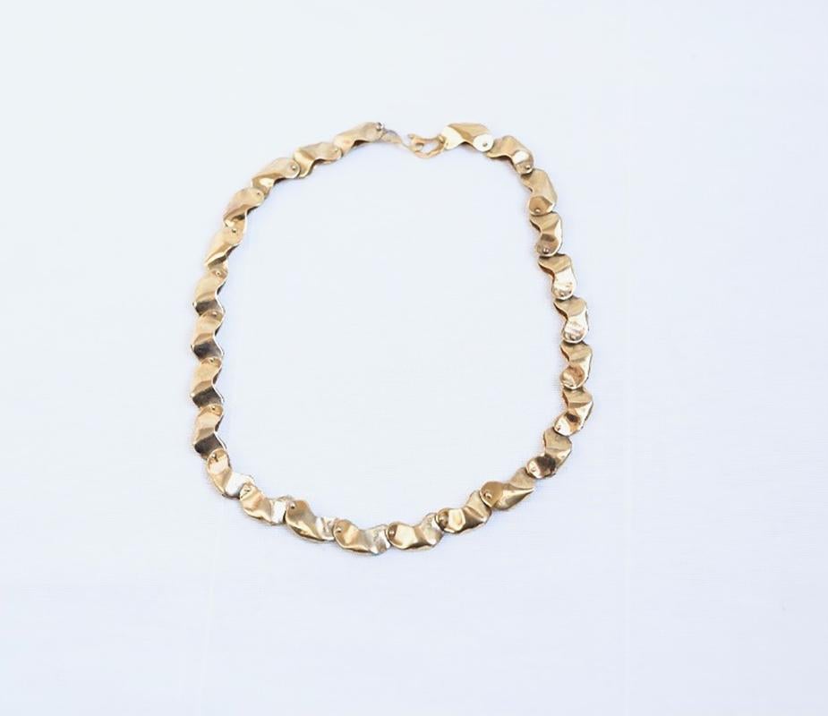 The Bean Neck Piece comes to life with hand crafted beans joined together with rivets, embracing the whimsical folklore stories of jumping magic beans, 14K Gold. This 14K Gold version of the Magic Bean Necklace is only available through 1stDibs.