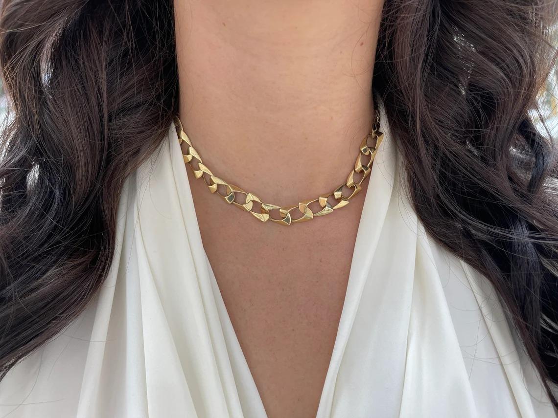 Featured is a classic, elegant, 16-inch gold necklace. This remarkable piece makes a statement anywhere that you may take it. It is crafted in solid 14K yellow gold with a unique 