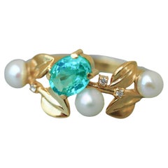 14k gold floral ring with oval neon paraiba apatite, diamonds and pearls. 