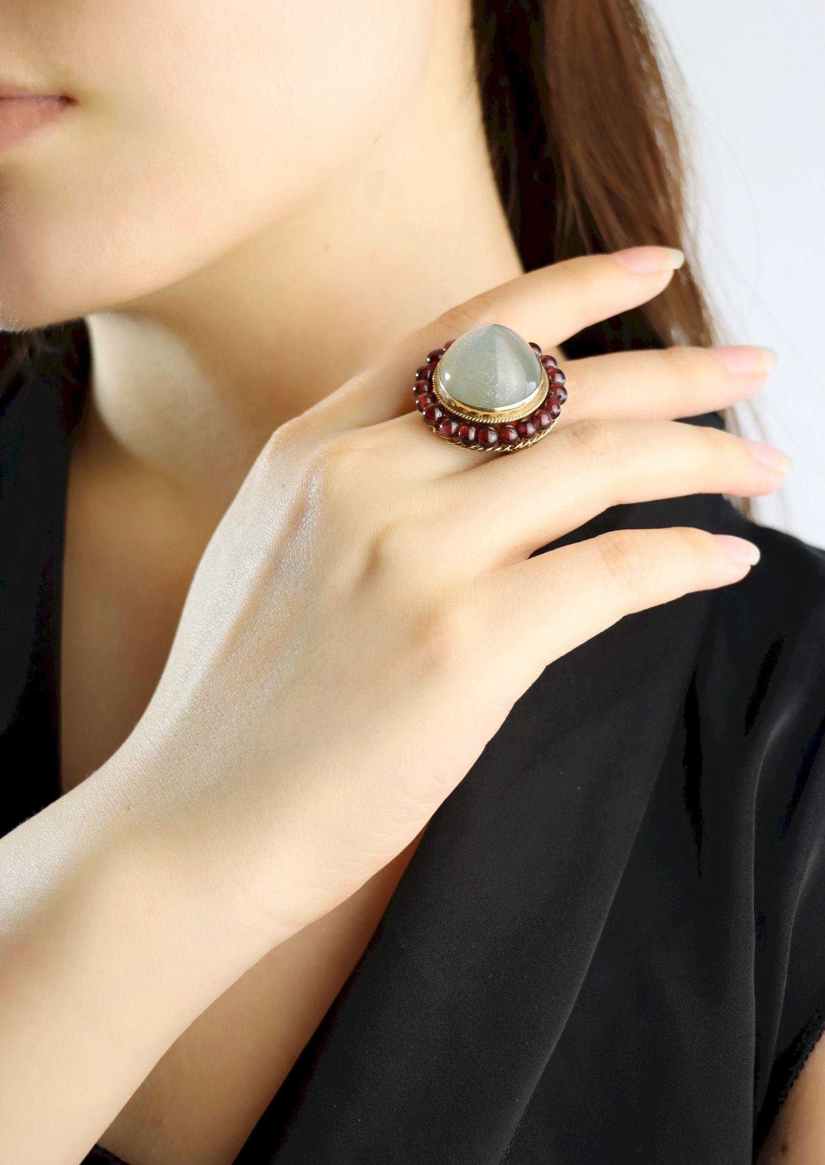 14K Gold Garnet Beads Moonstone Ring

Approximate Dimensions:
6.75 (Ring Size)
18.42 mm (Width) x 18.12 mm (Depth) (Moonstone)
16.0 grams in weight.

** All dimensions listed above are approximations based on our measurements and findings - Diamonds