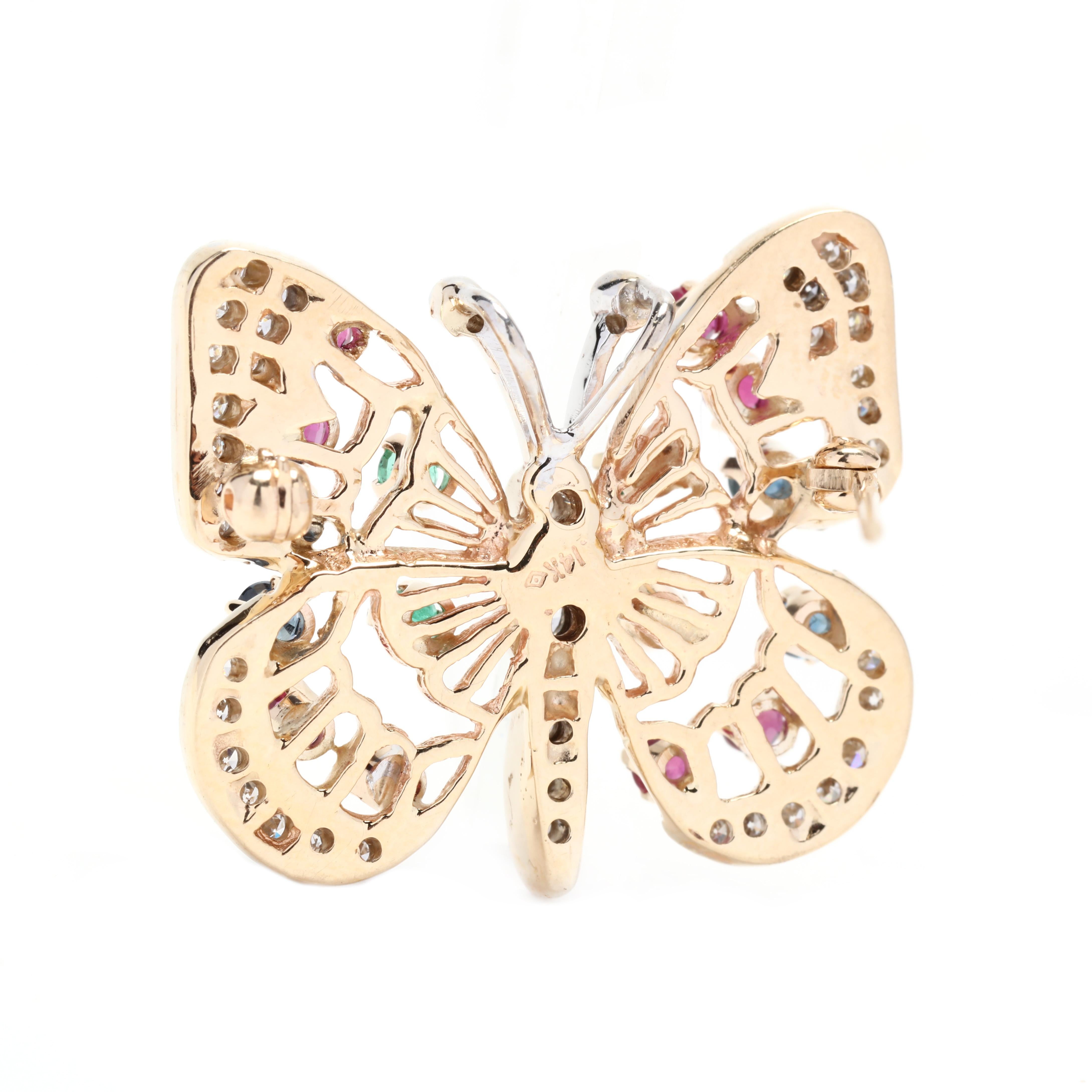 A vintage 14 karat yellow and white gold multi gem-set butterfly brooch. This brooch features a butterfly motif set with round cut sapphires weighing approximately .14 total carats, round cut rubies weighing approximately .40 total carats, round cut