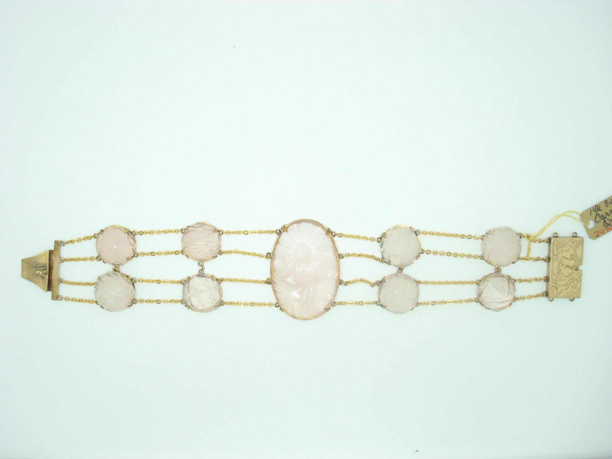 14k Gold Genuine Natural Rose Quartz Bracelet and Earring Set (#J2470)

Gorgeous 14k yellow gold bracelet and earring set featuring lovely carved rose quartz. There is an oval rose quartz set in the center of the bracelet, which measures 36x25mm,