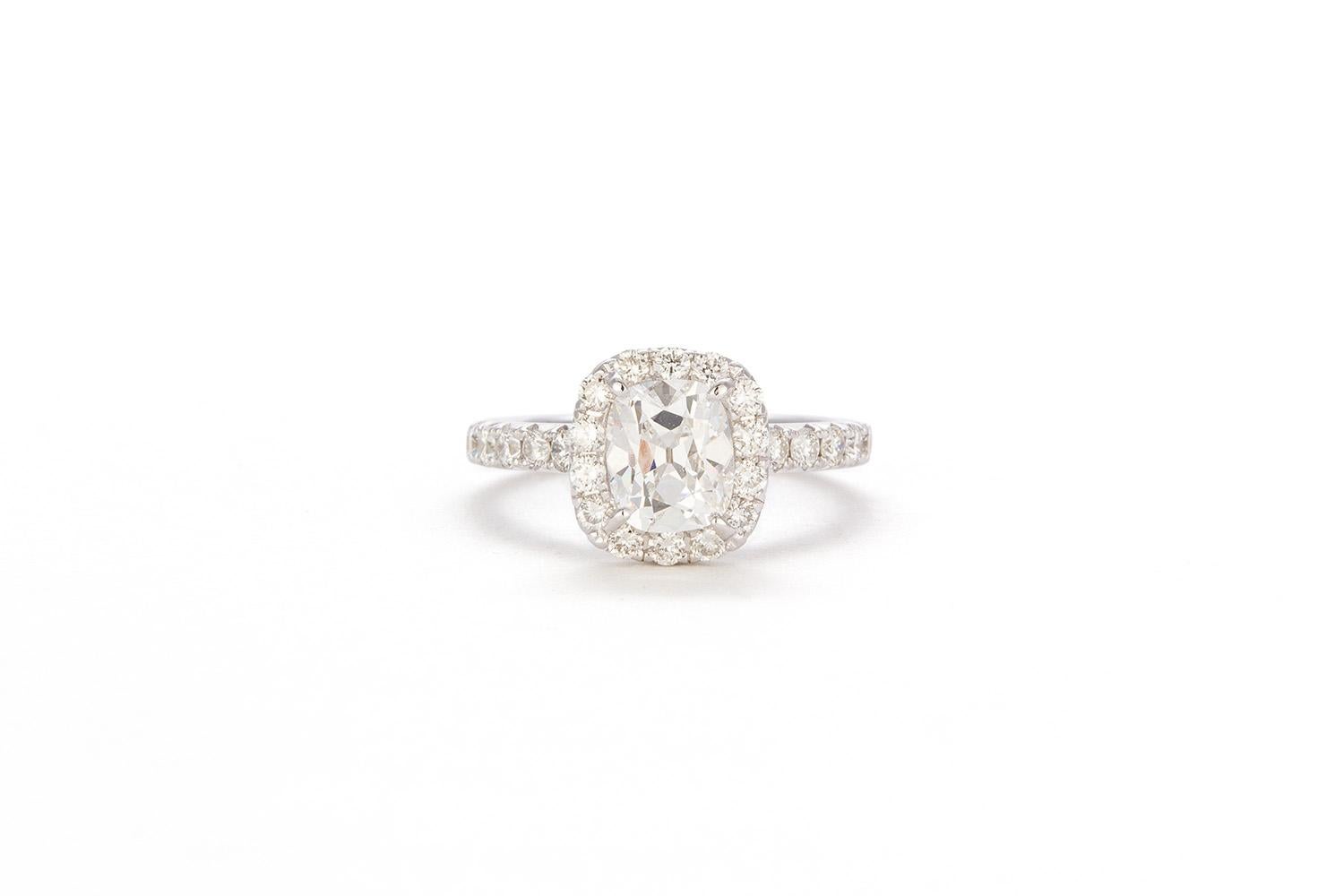 We are very pleased to present this remarkable 18k White Gold GIA Certified Cushion Cut Diamond Halo Engagement Ring. This stunning ring features a GIA Certified 1.31ct F/VVS2 Cushion Cut Diamond set in a 14k white gold halo ring accented by 0.56ctw