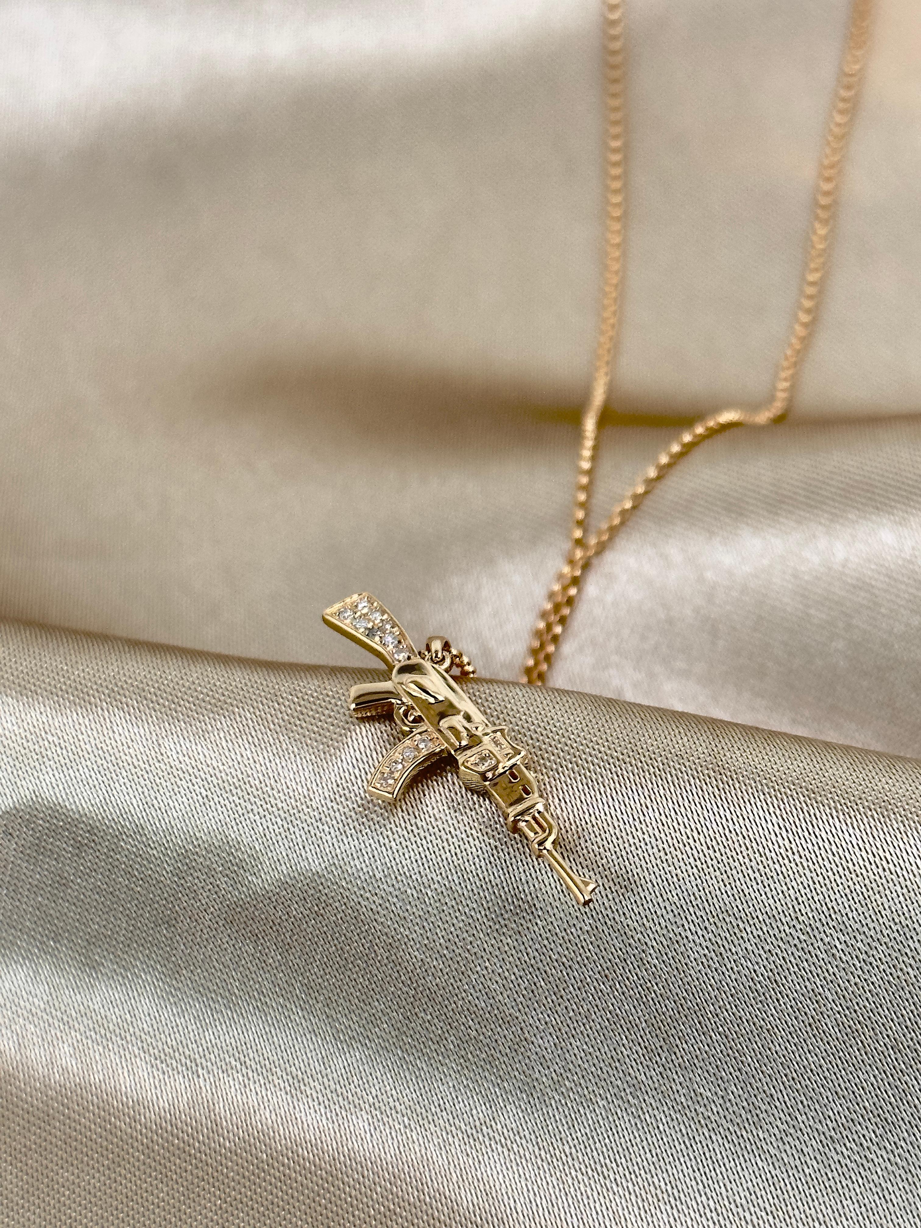 14k gold Diamond gun necklace

** Each item sold separately **

This collection is crafted in 14k solid yellow gold with natural Diamonds. Looks super cute layered with other necklaces, or worn solo.
The chain can be adjusted from 14-18 inches, so