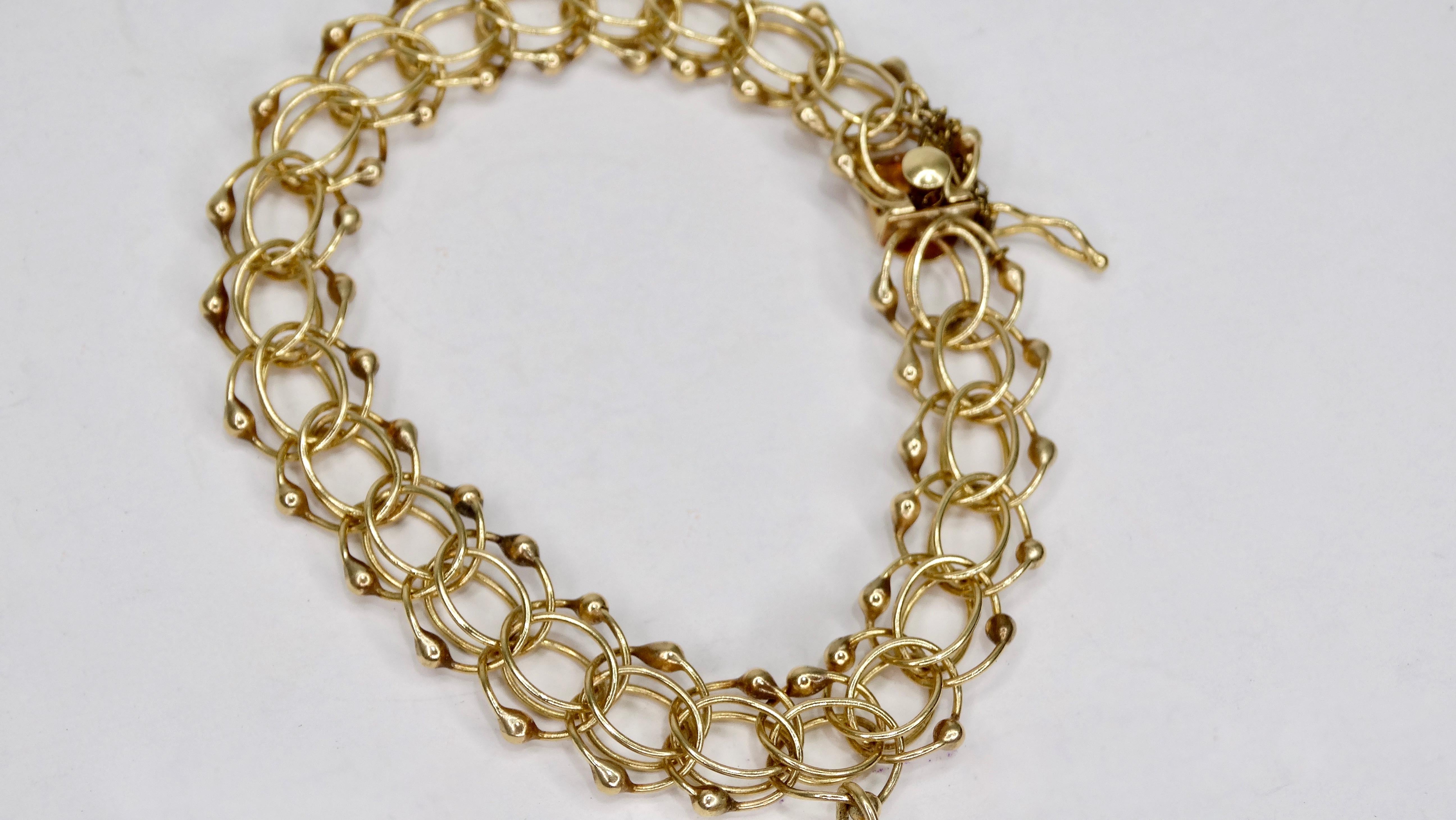 Stunning 14k Gold bracelet circa mid 20th century featuring a decorative multi chain link bracelet with a vintage heart locket charm. Tab closure. Best fit for a size 7-8