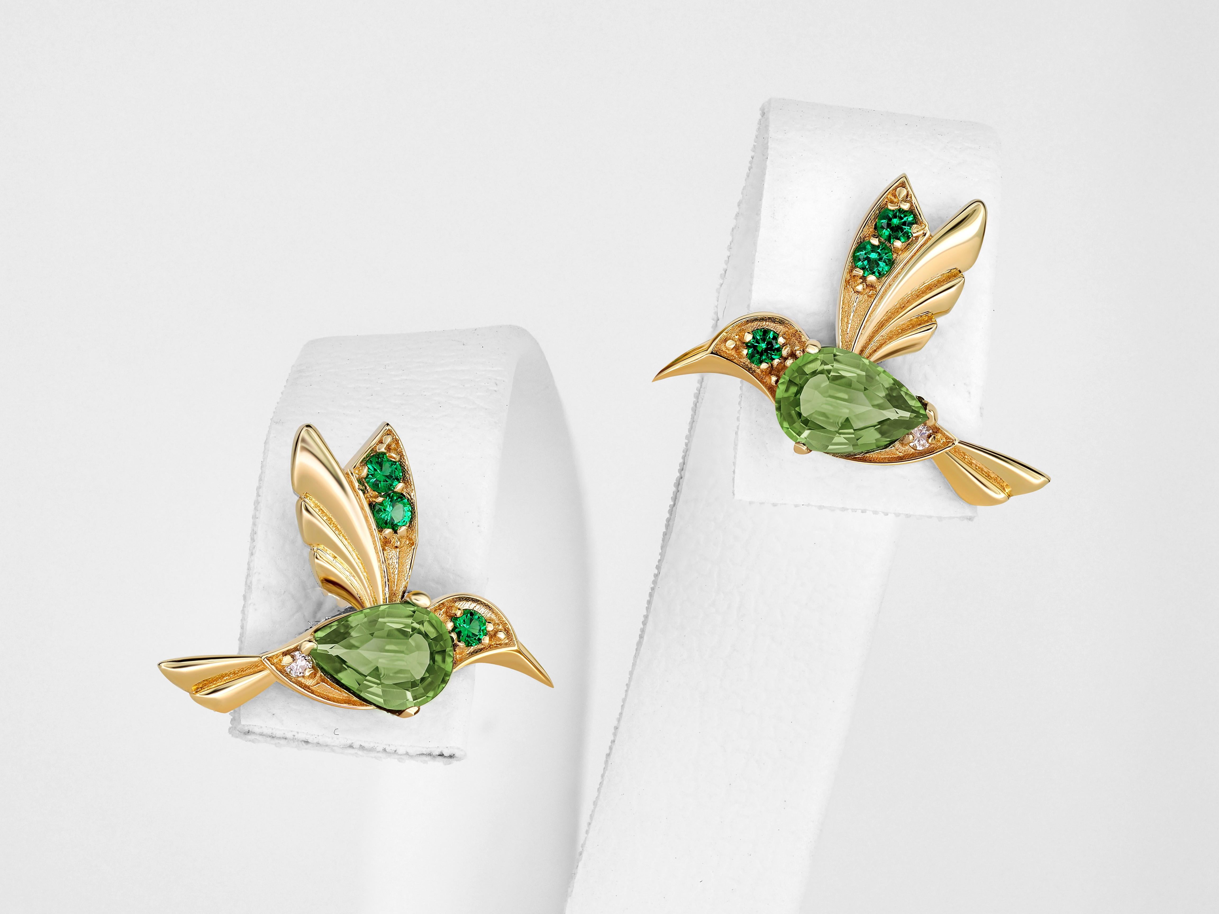 Modern 14k Gold Hummingbird earrings studs with peridots.  For Sale