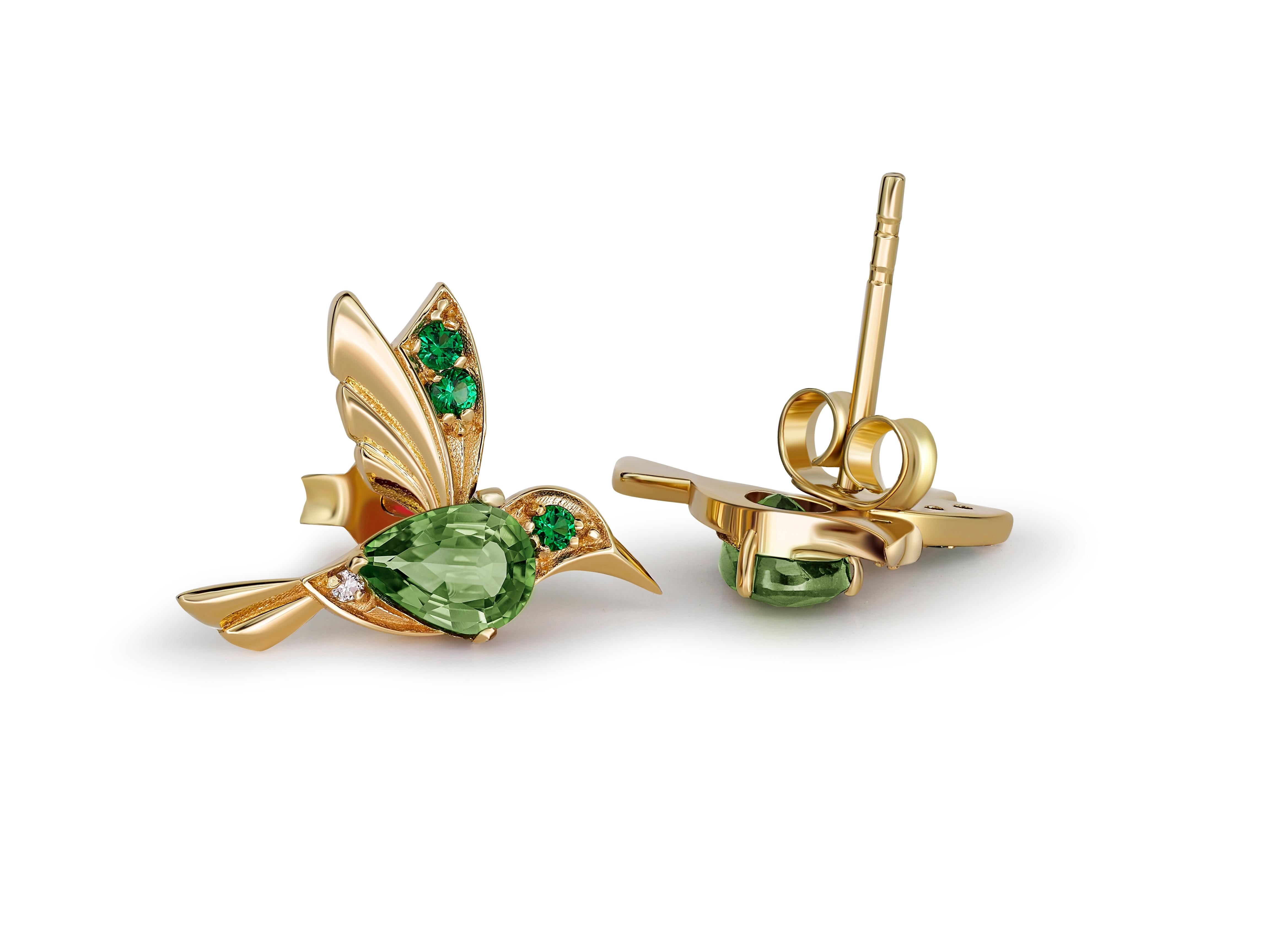 Pear Cut 14k Gold Hummingbird earrings studs with peridots.  For Sale