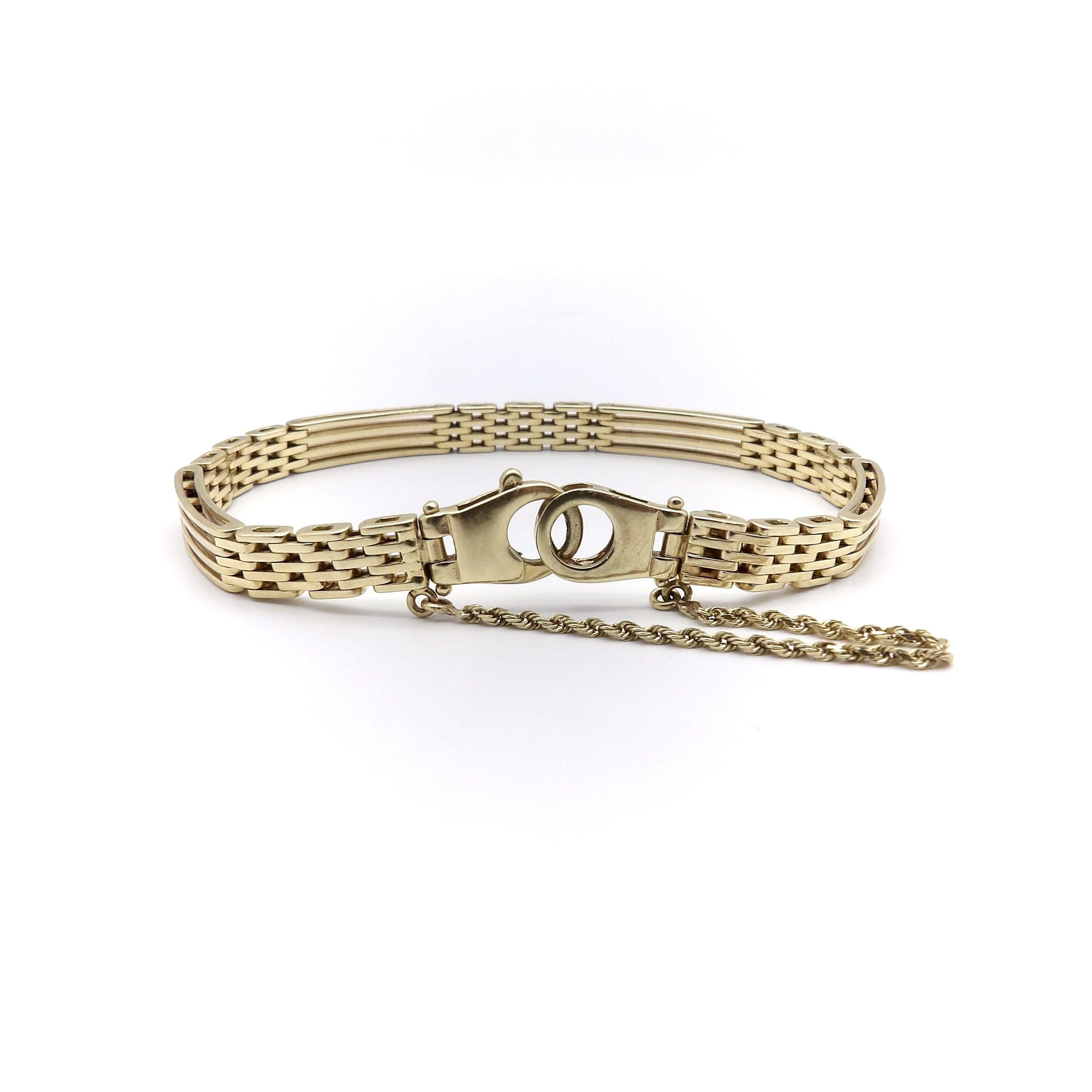 The style of this 14k gold Italian bracelet is reminiscent of an English gate bracelet. The piece is clean and sleek, with elongated bars that appear to be woven in every other section. The alternating lines create a mesmerizing pattern for a