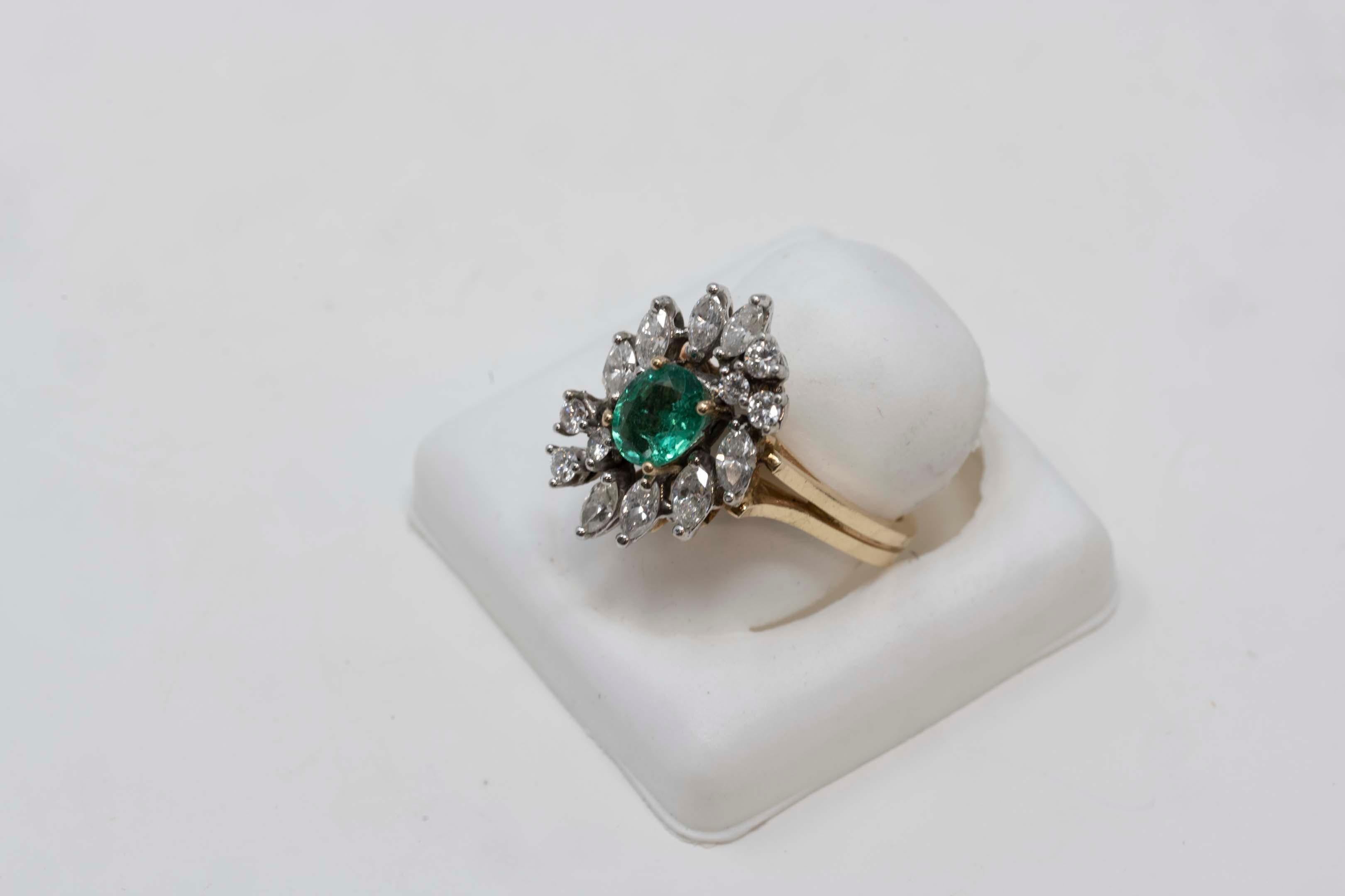 Ladies ring in 14k yellow and white gold (stamped, modern style, bright finish. No maker mark. Total weight of ring: 5.8 grams. The ring is set with 1 oval-shaped, mixed cut natural emerald. Weighs 0.65 ct, measures 6.87 x 5.66 x 3.03 mm. Hue: