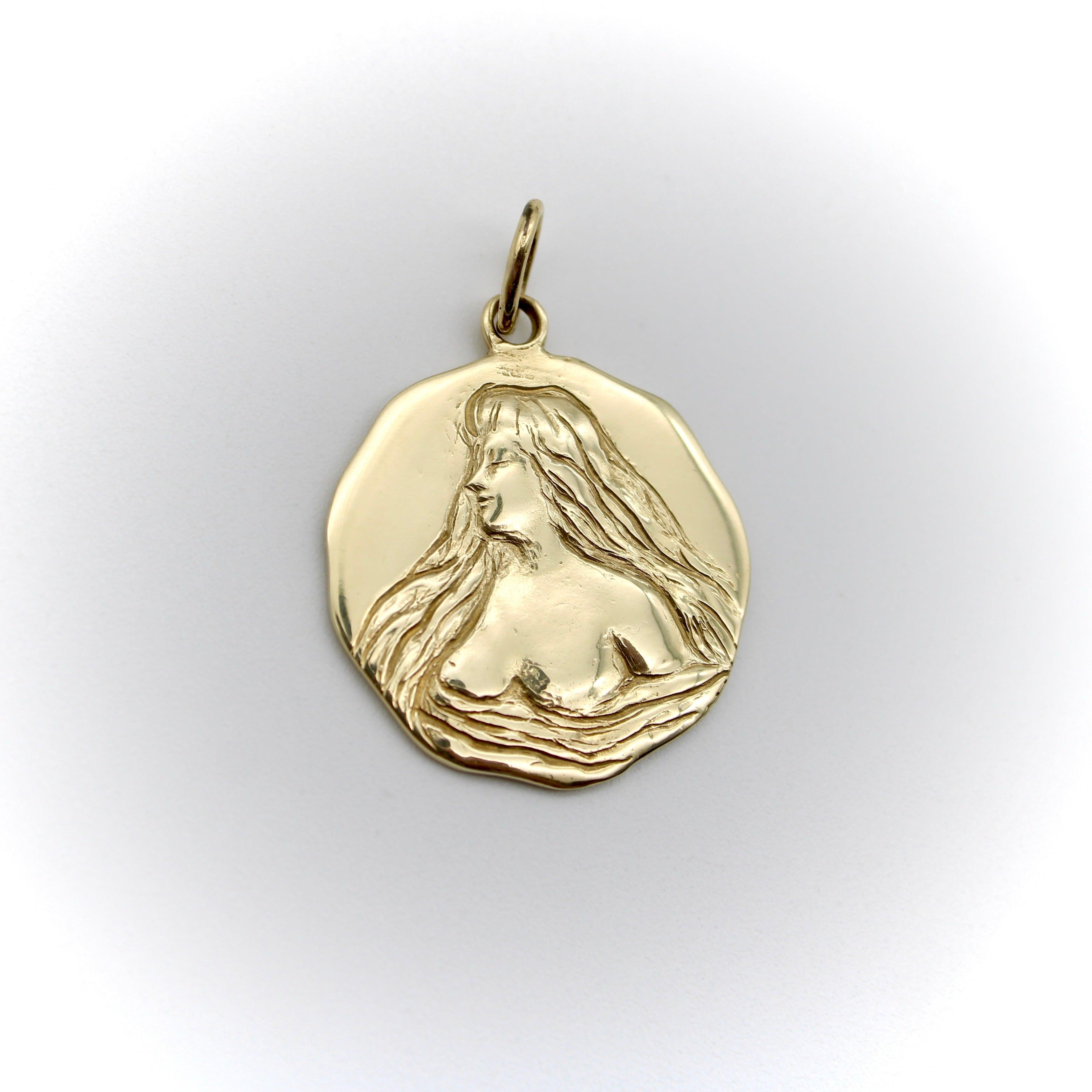 The image on this 14k gold medallion was originally taken from an Art Nouveau locket. Kirsten’s Corner created a mold using the face of the locket, and then hand-carved details to emphasize and add depth to the original design. The maiden is