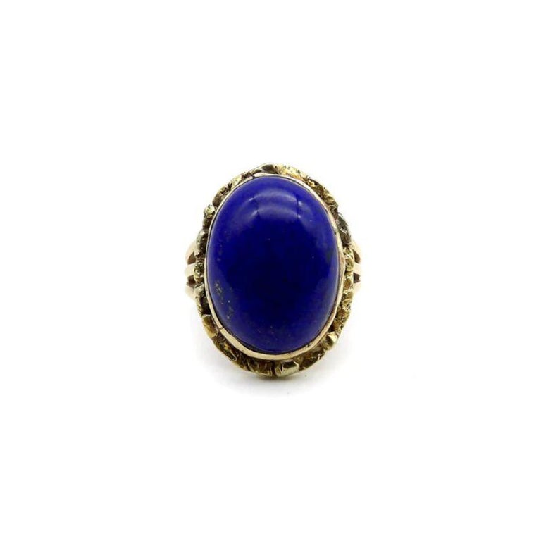 A vivid blue lapis cabochon is bezel set into a halo of 22k gold nuggets. The stone is a deep, well-saturated cobalt blue, while the gold nuggets bring richness and texture to the surface of the ring. The effect is stunning, and the two elements