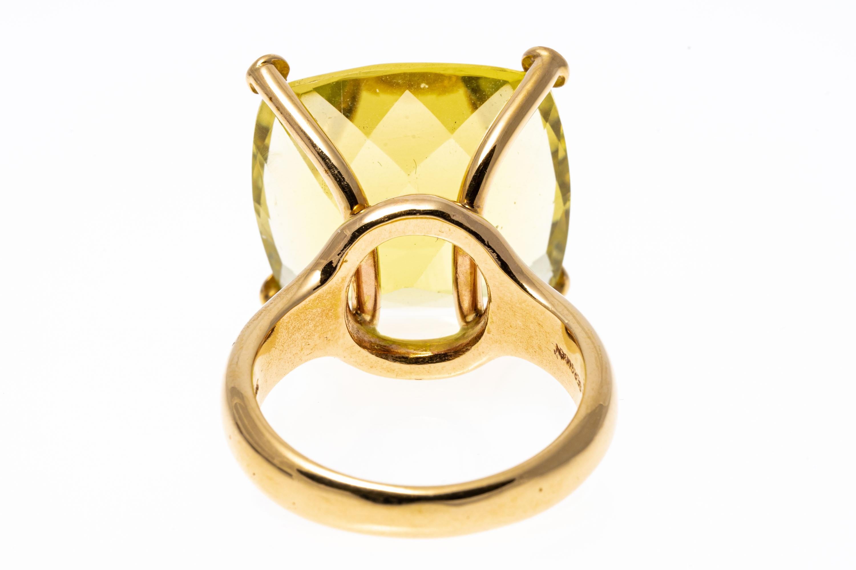 14k yellow gold ring. This gorgeous, contemporary chunky square cushion, solitaire lemon lime citrine, approximately 21.41 CTS, set with decorative prongs atop a wide, high polished shank.
Marks: 14k
Dimensions: 11/16