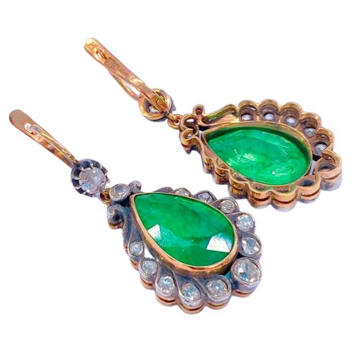 14k gold large natural green emerald in antique style earrings centered with large pear shape emerald with a diameter of 15.65mm×10.50mm each stone flanked with old mine cut diamonds with an estimate weight of 2 carats 
