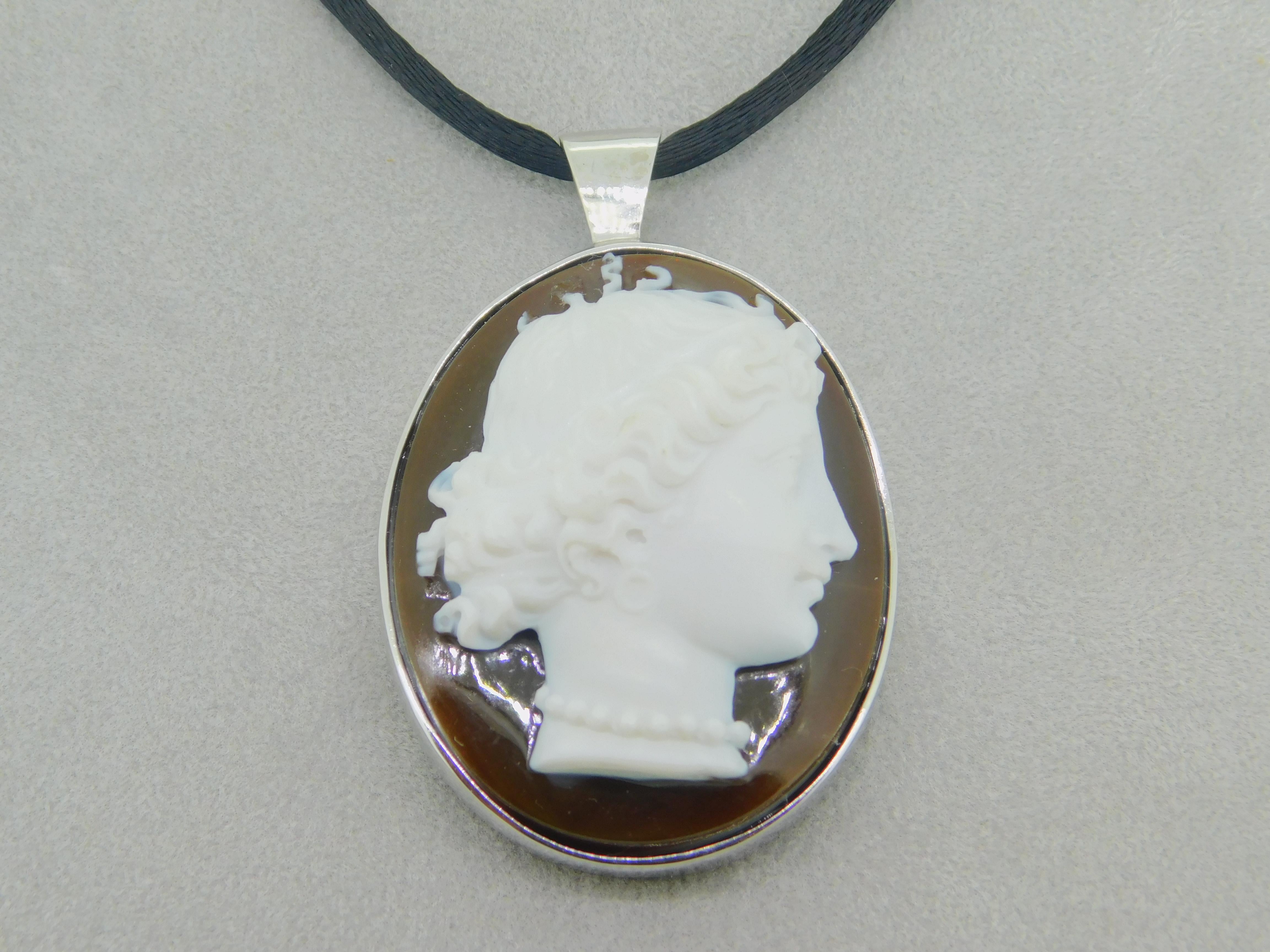 14k Gold Large Genuine Natural Agate Hard Stone Cameo Pendant (#J4136)

14k white gold pendant featuring a large oval brown and white agate cameo. The cameo measures 40.1mm x 32.5mm. The Victorian cameo dates from the 1880's with a new 14k custom