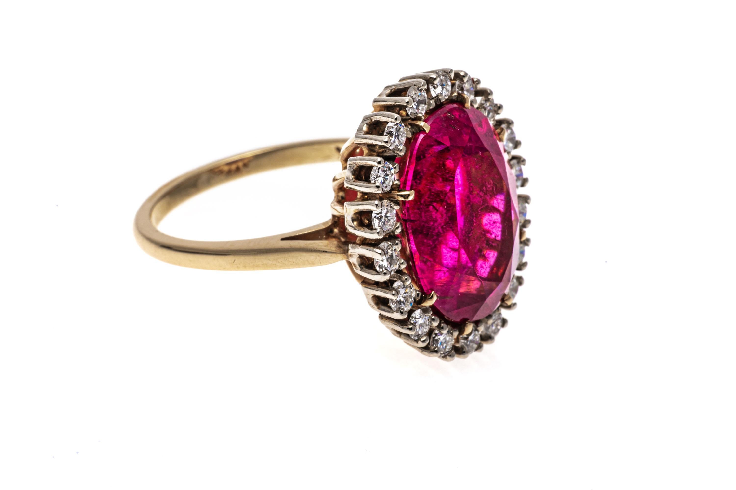 14k gold ring. This stunning ring is a Lady Di style, with a large faceted oval shape, medium to dark pink color pink tourmaline center, prong set, and approximately 6.62 CTS. Surrounding the stone is a halo of round brilliant cut diamonds,