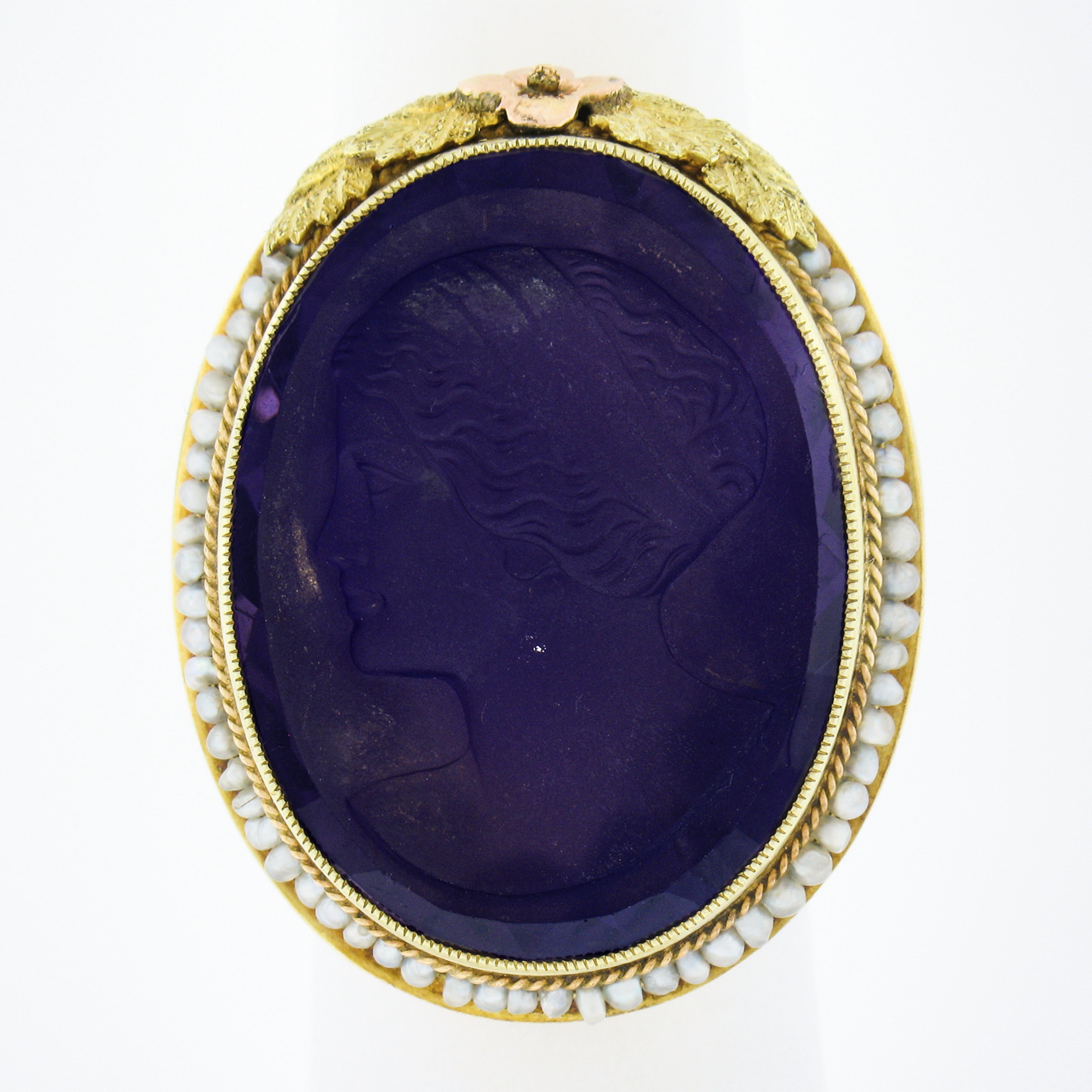 This rare antique art deco ring was crafted from solid 14k yellow & green gold with rose gold accents. It features a detailed carved amethyst left facing cameo neatly bezel set at the center of the ring. The outstanding carving shows a detailed