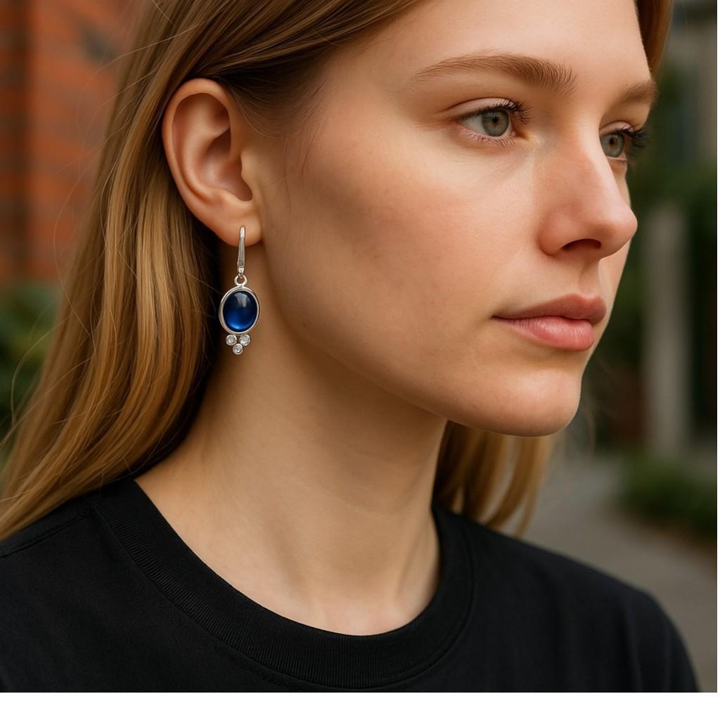 Indulge in the rich allure of natural gemstones with these 14K White Gold Cabochon Sapphire and Diamond Lever Back Earrings, a true testament to timeless luxury and refined elegance. Each earring features a beautifully polished cabochon sapphire