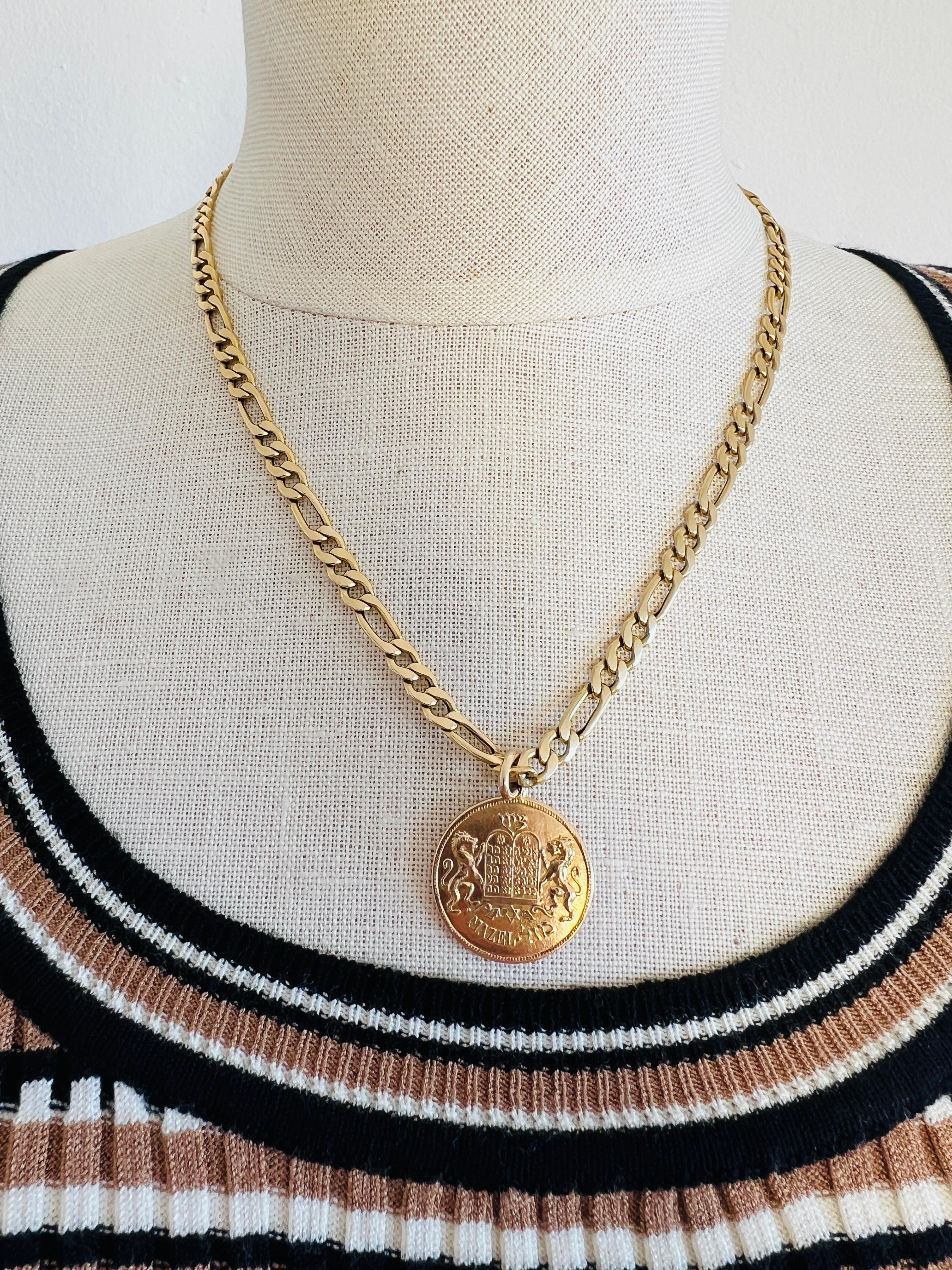 This fabulous vintage 14K yellow gold pendant has been thoughtfully paired with a bold Figaro link chain to enhance its elegance, though they did not originally arrive together. 

The pendant beautifully blends Jewish symbolism and tradition,